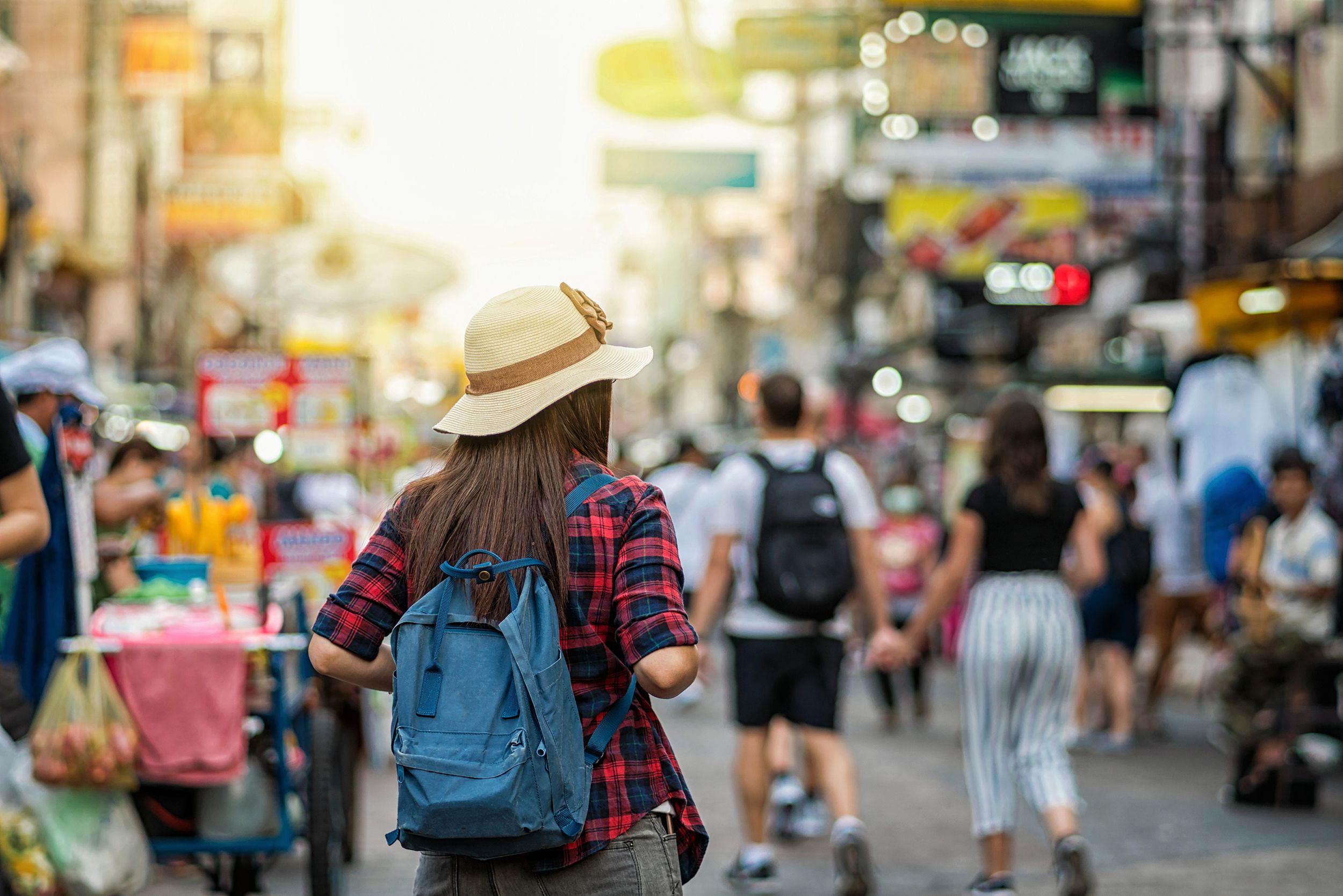 back side of Young Asian traveling women walking and looking in Khaosan Road, Bangkok, Thailand