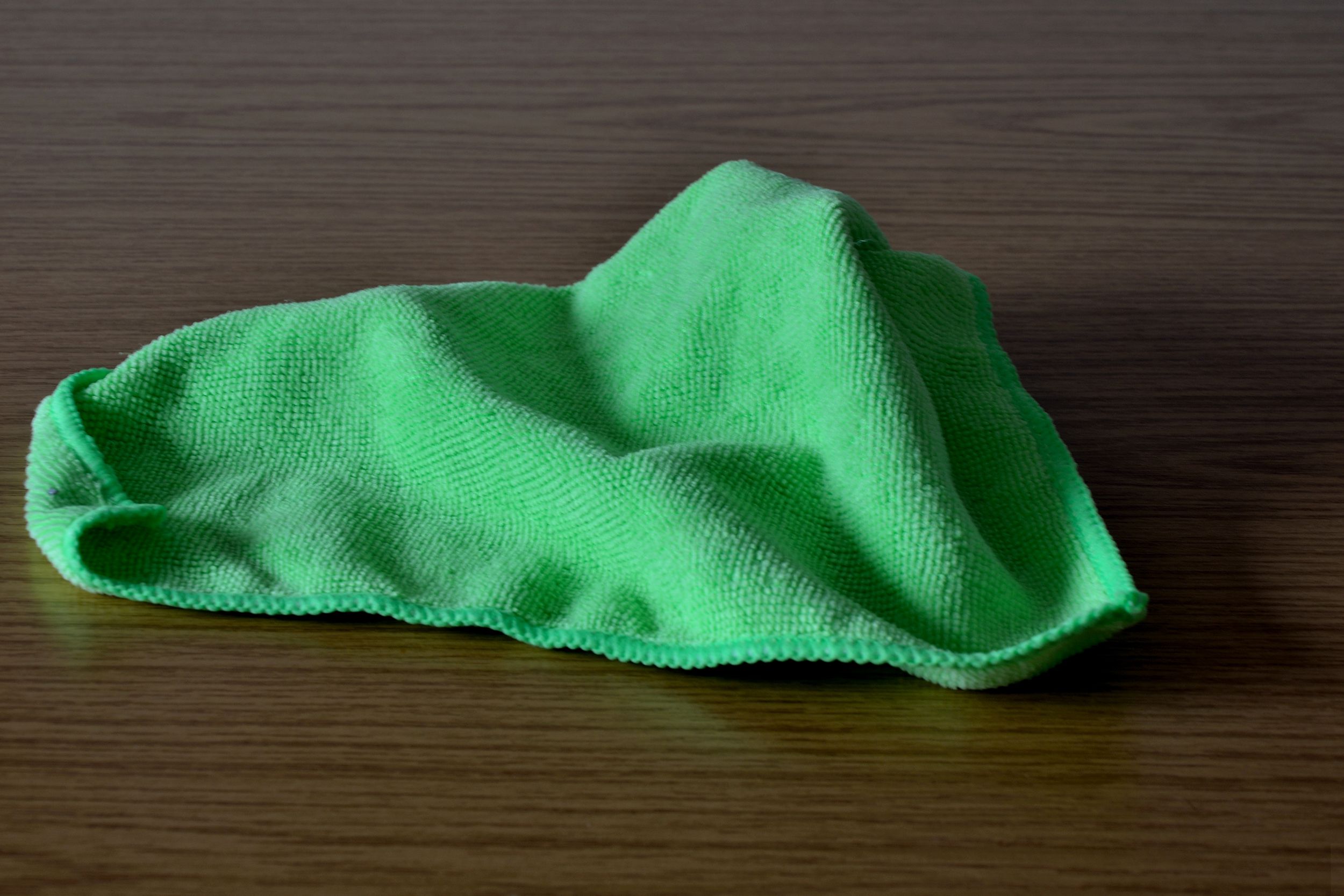 green microfiber cleaning cloth on table