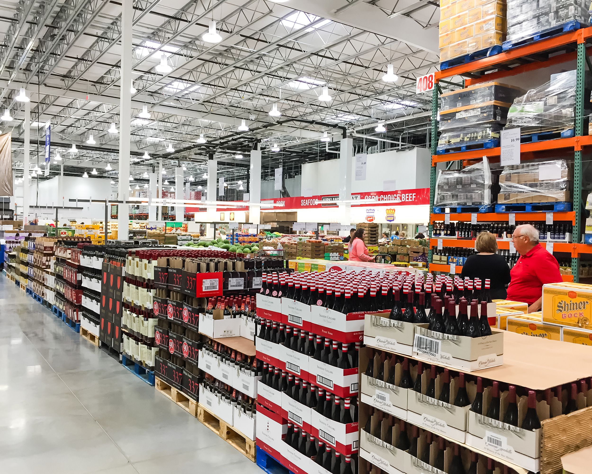 Aisle of bottles in wine section of Costco store.
