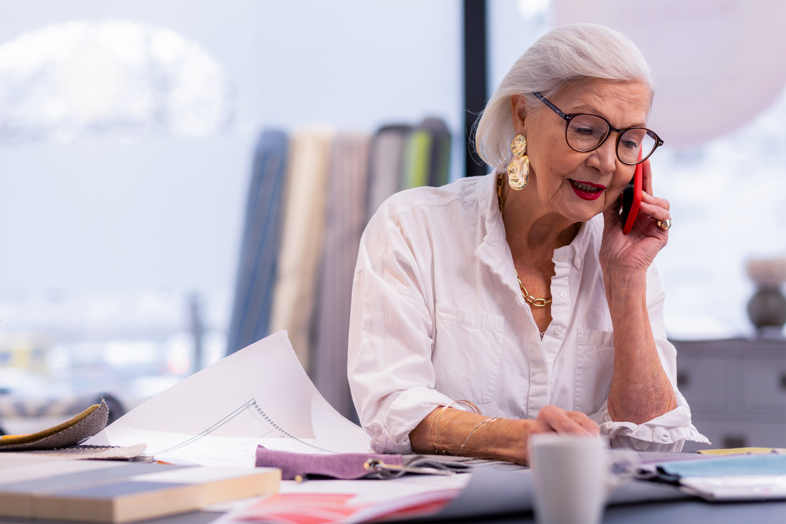 senior woman taking on phone in an office