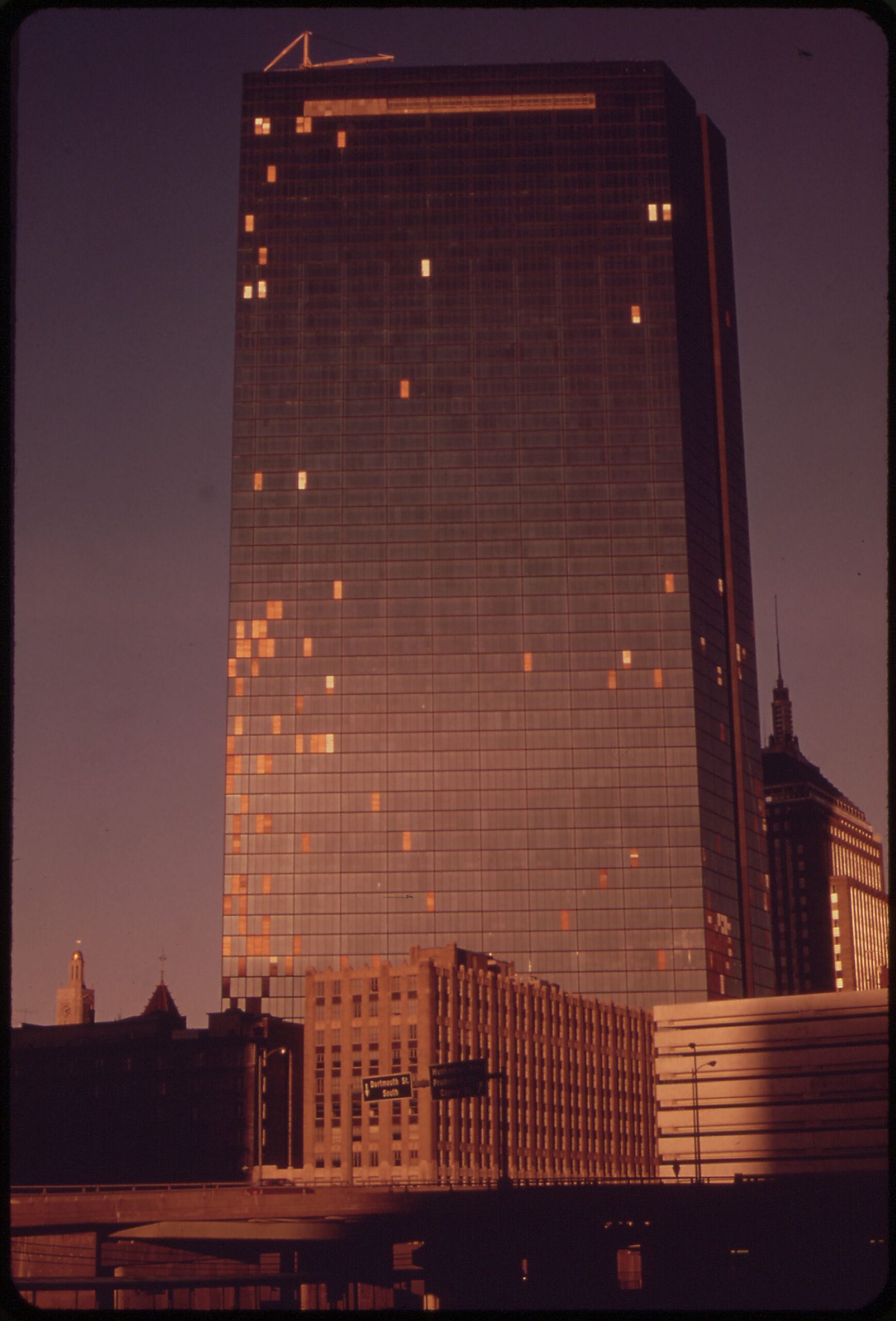 THE JOHN HANCOCK BUILDING, CONCEIVED AS A BRIGHT WINDOWED DREAM OF A SKYSCRAPER, HAS BECOME A BROKEN WINDOWED NIGHTMARE