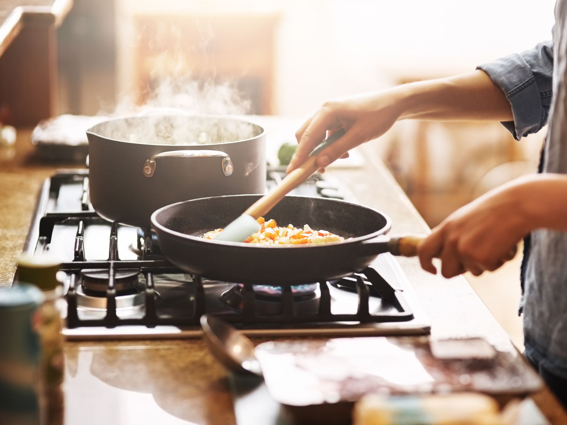 Cropped shot of a young woman preparing a meal at home