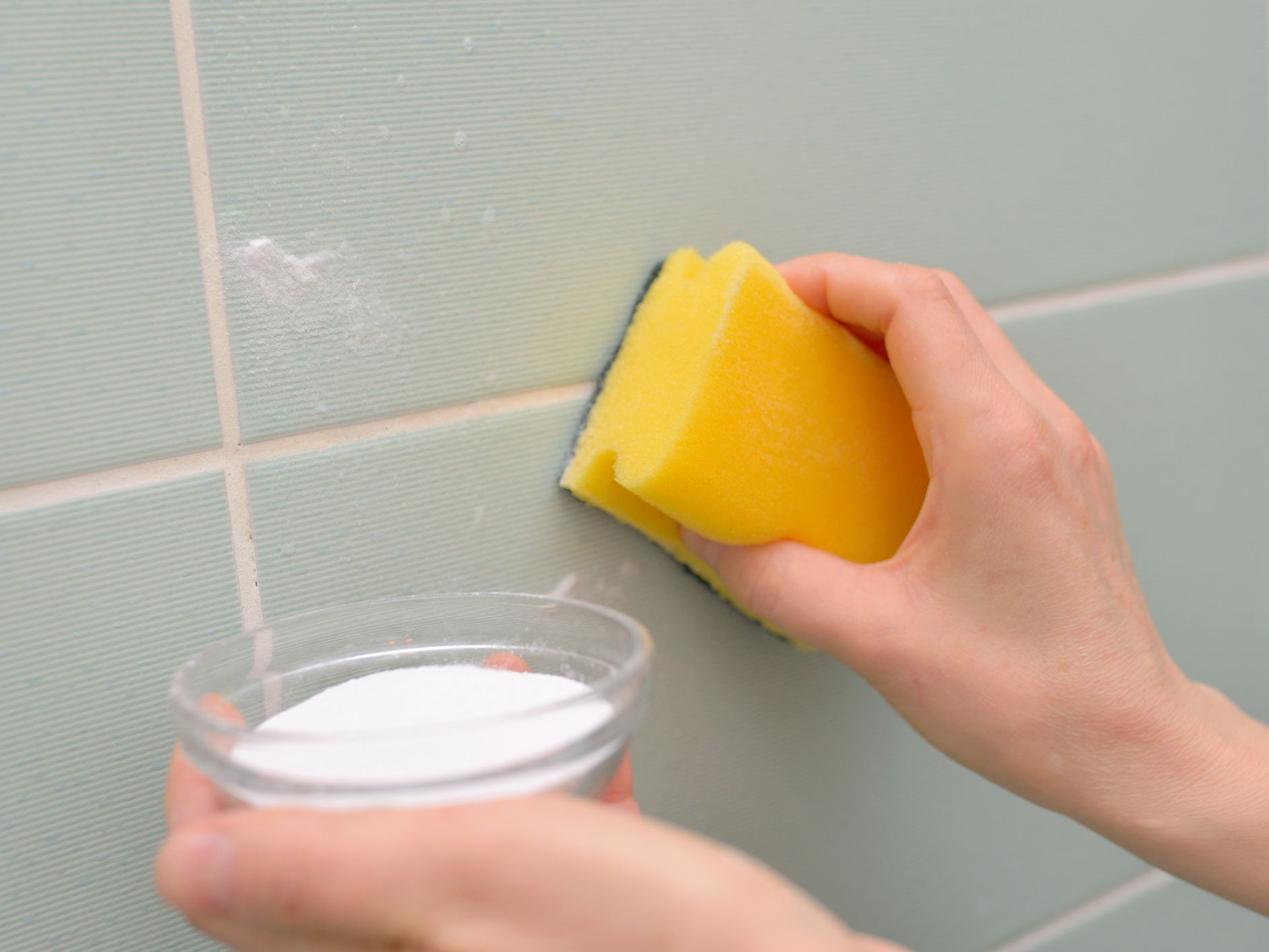 Cleaning tile with baking soda and sponge