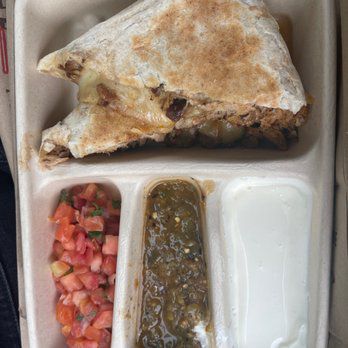 a quesadilla from chipotle with three salsas