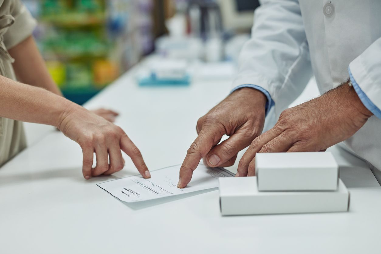 Cropped shot of a customer getting her prescription filled at a chemist