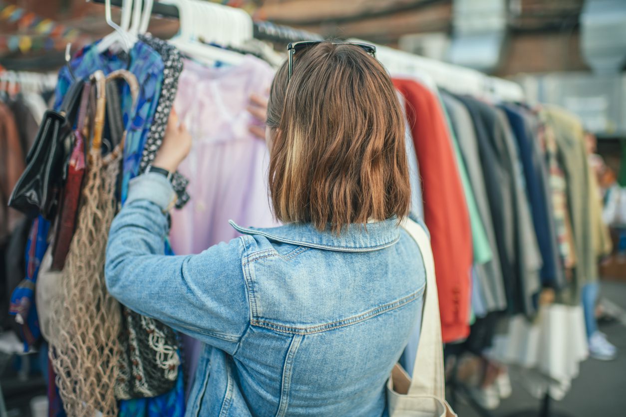 Young girl shopping in a second hand market in summer, zero waste concept
