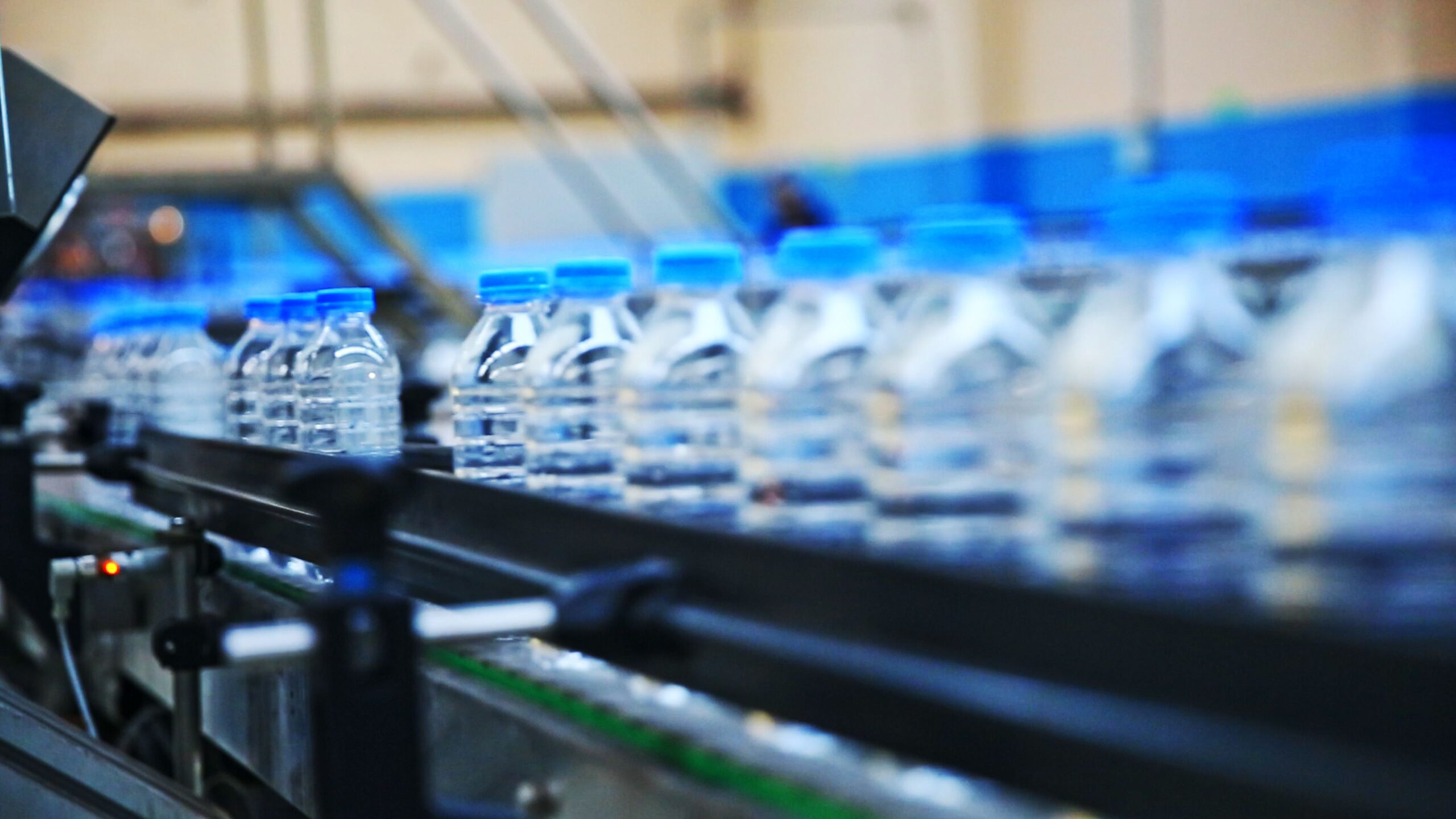Plastic water bottles in factory on conveyor belt