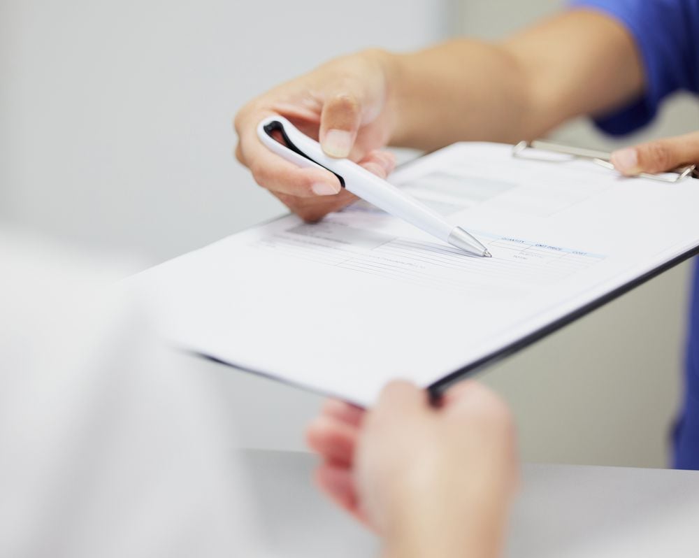 Shot of two unrecognizable people discussing a contract in a office