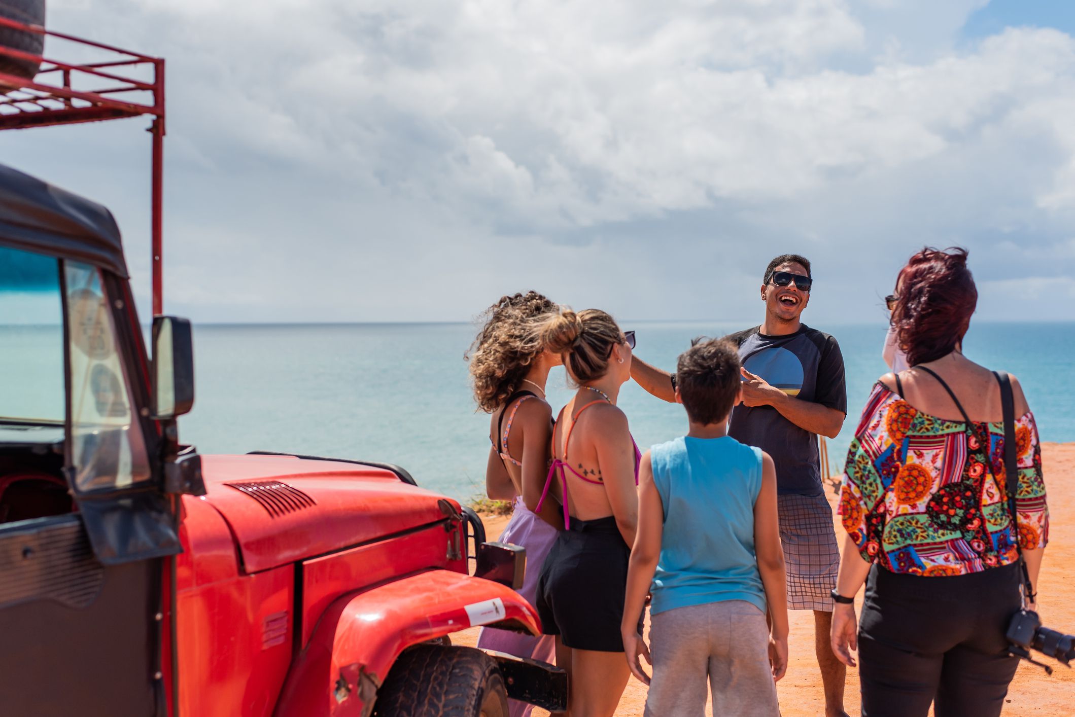 Tourist family listening to tour guide on the beach, Brazil, Rio Grande Do Norte