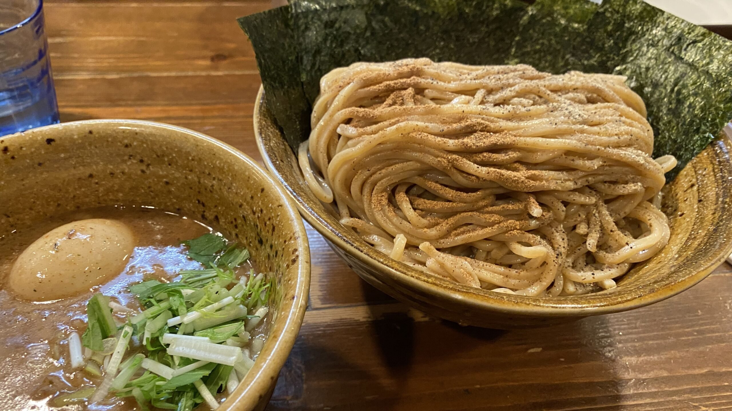 A plate of delicious asian ramen and a soup dipping sauce
