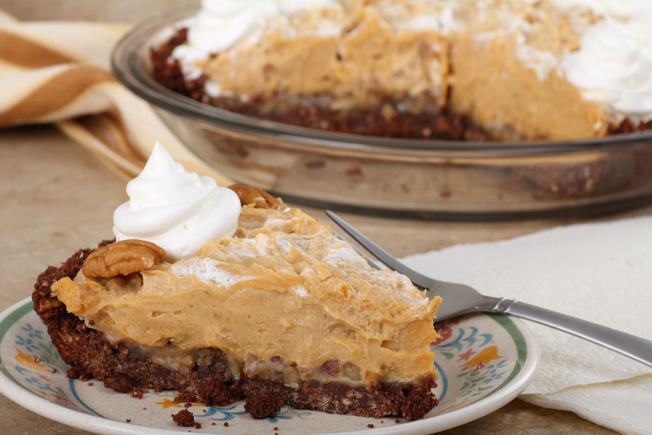 Slice of peanut butter pie with whipped cream on a plate