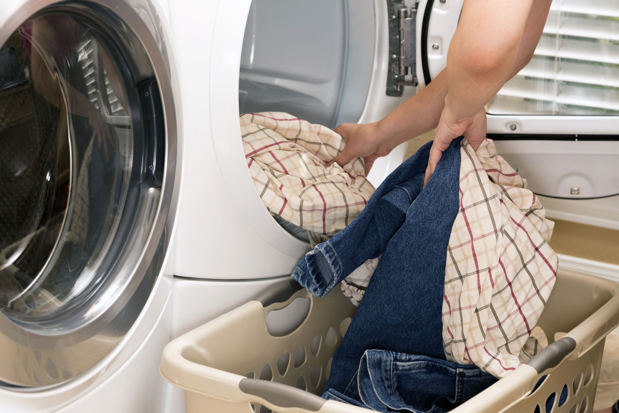 hands pulling clothes out of dryer