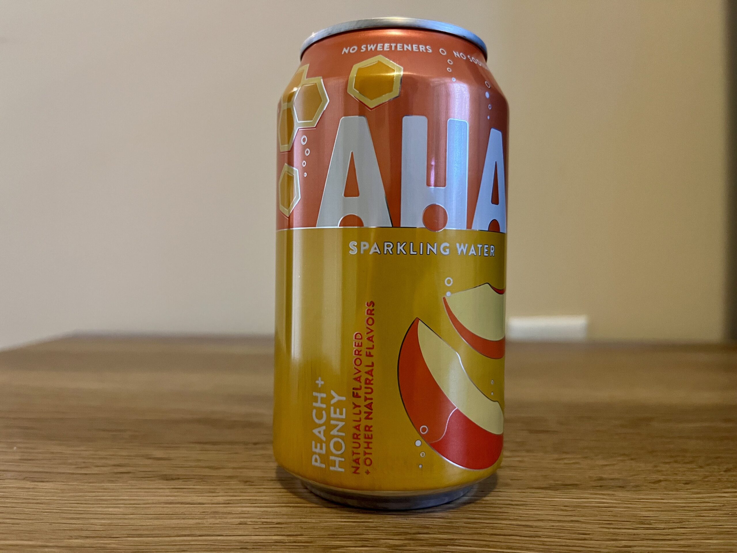 a can of peach honey aha sparkling water