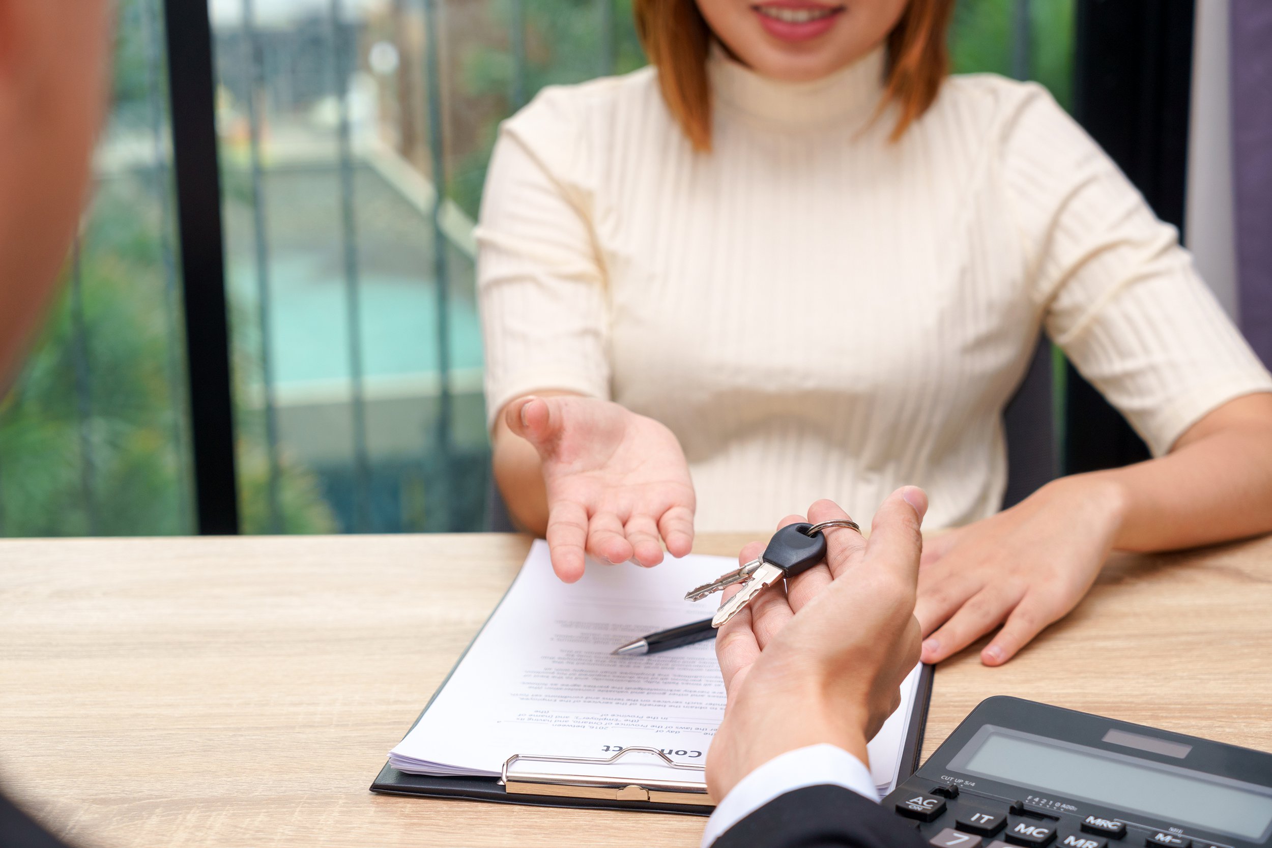 Woman signing contract to rent a car