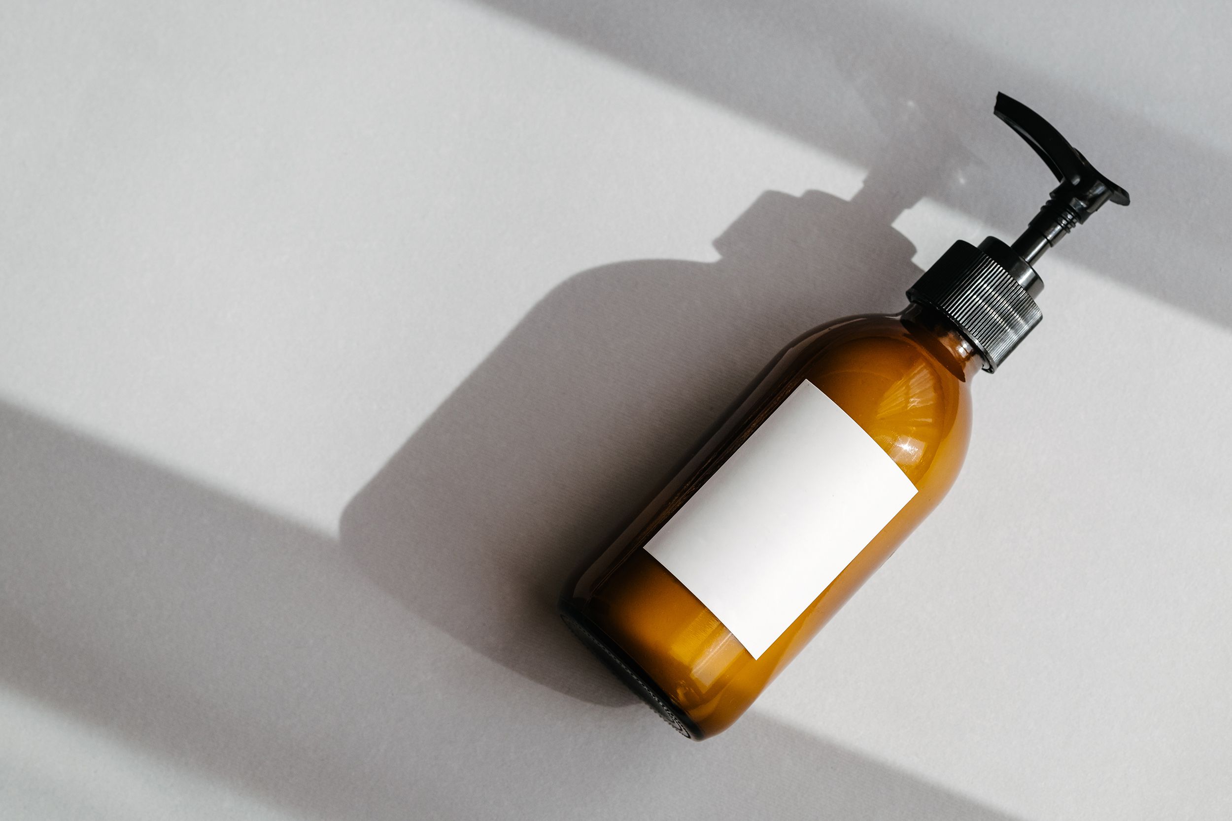 glass brown cosmetics bottle with white label
