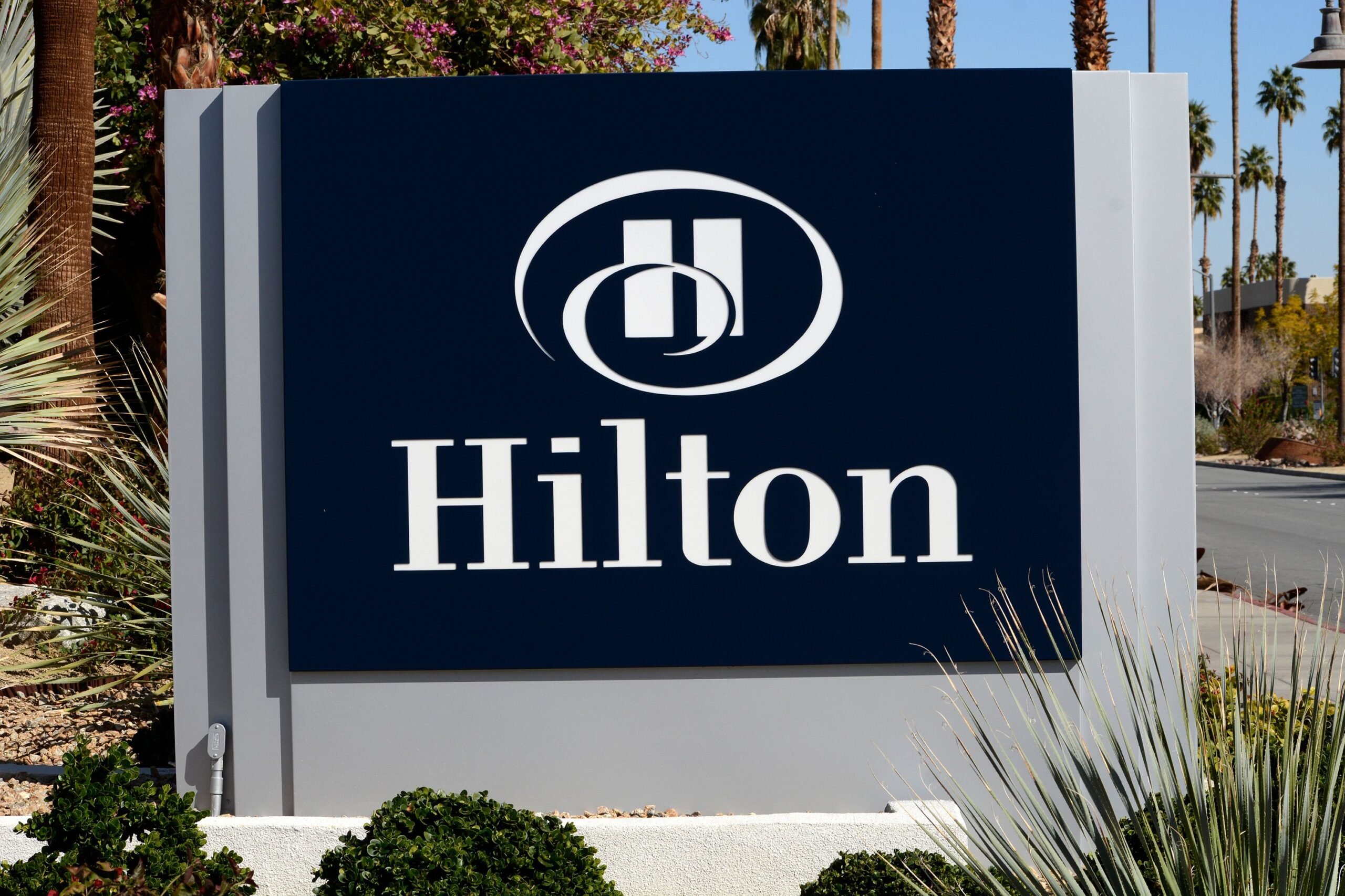 A business sign in front of a Hilton Hotel in Palm Springs, California.