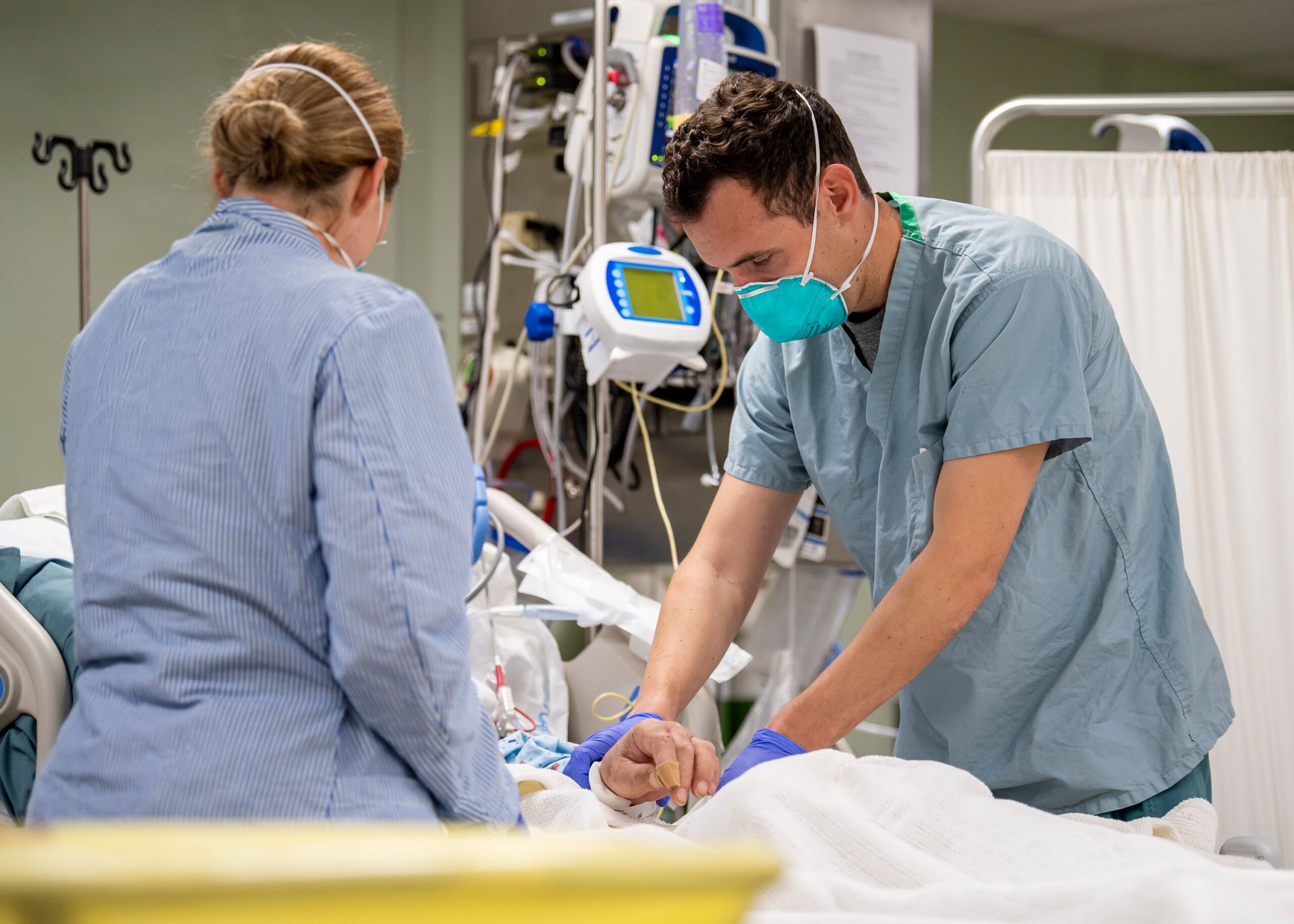 In this handout released by the U.S. Navy, Lt. Wade Miller, from Orlando, Fla., treats a patient aboard the hospital ship USNS Mercy