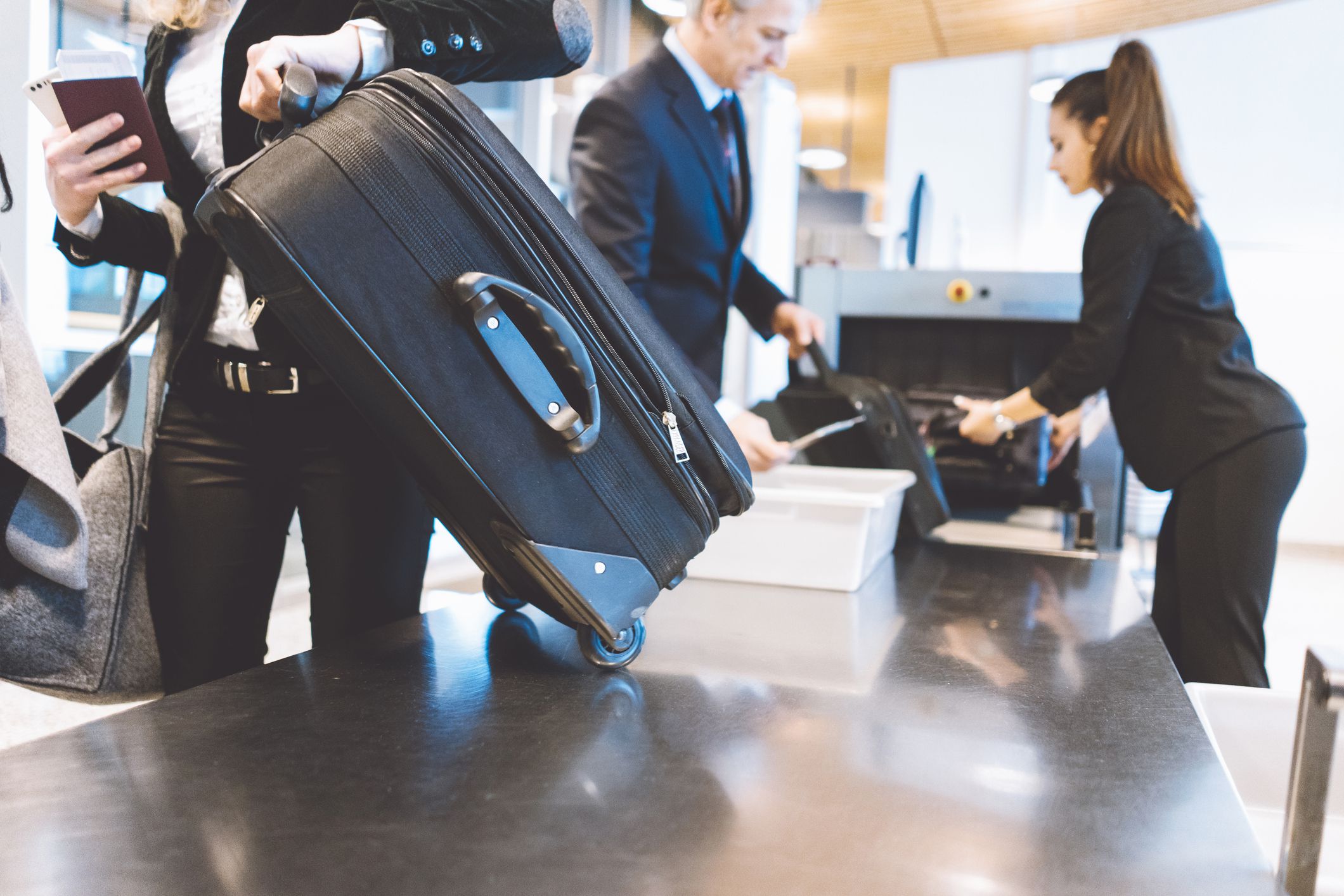 Passengers going trough security check at the airport.