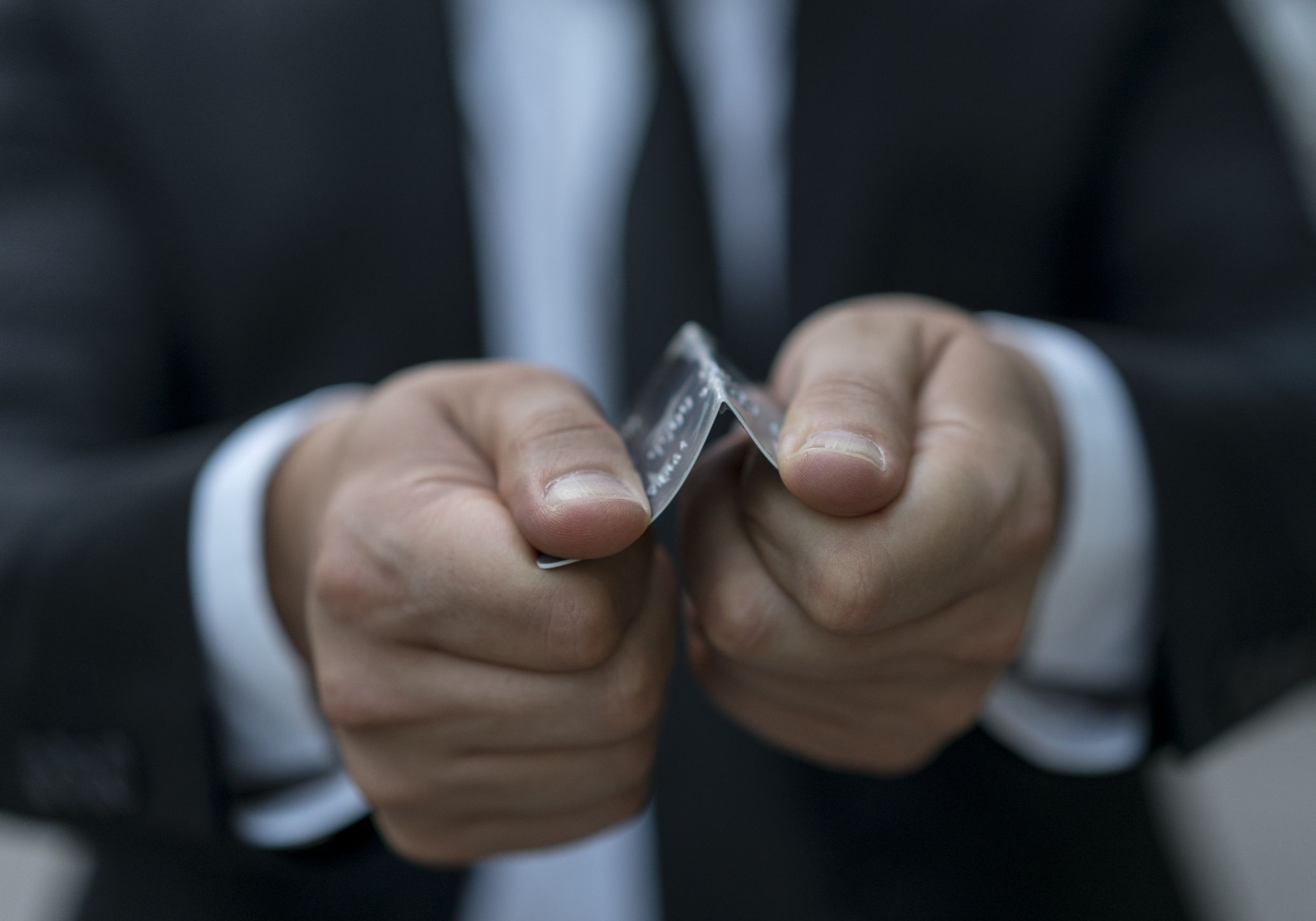 Businessman tearing up credit card