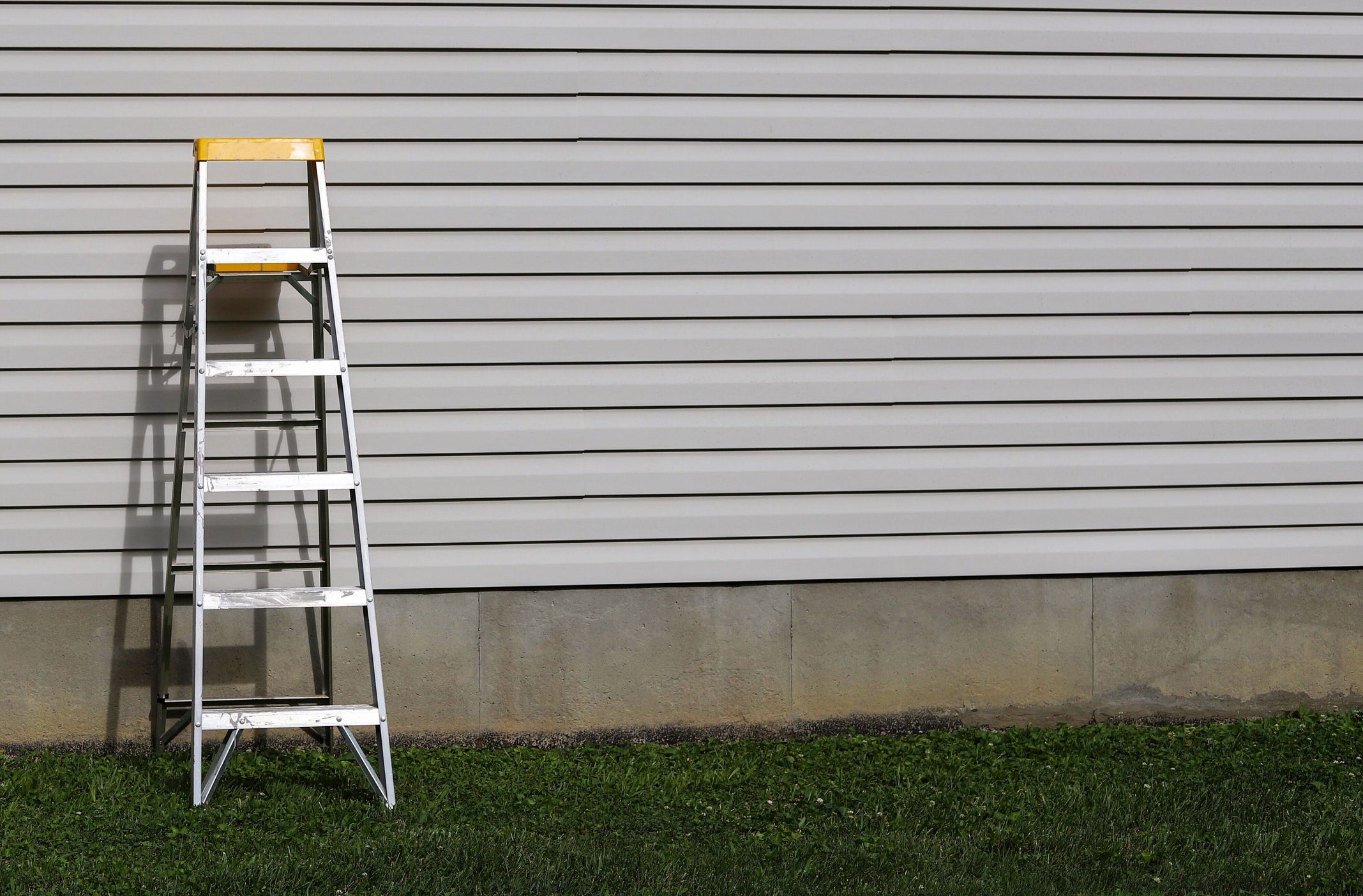 A step ladder against a side of a residential home