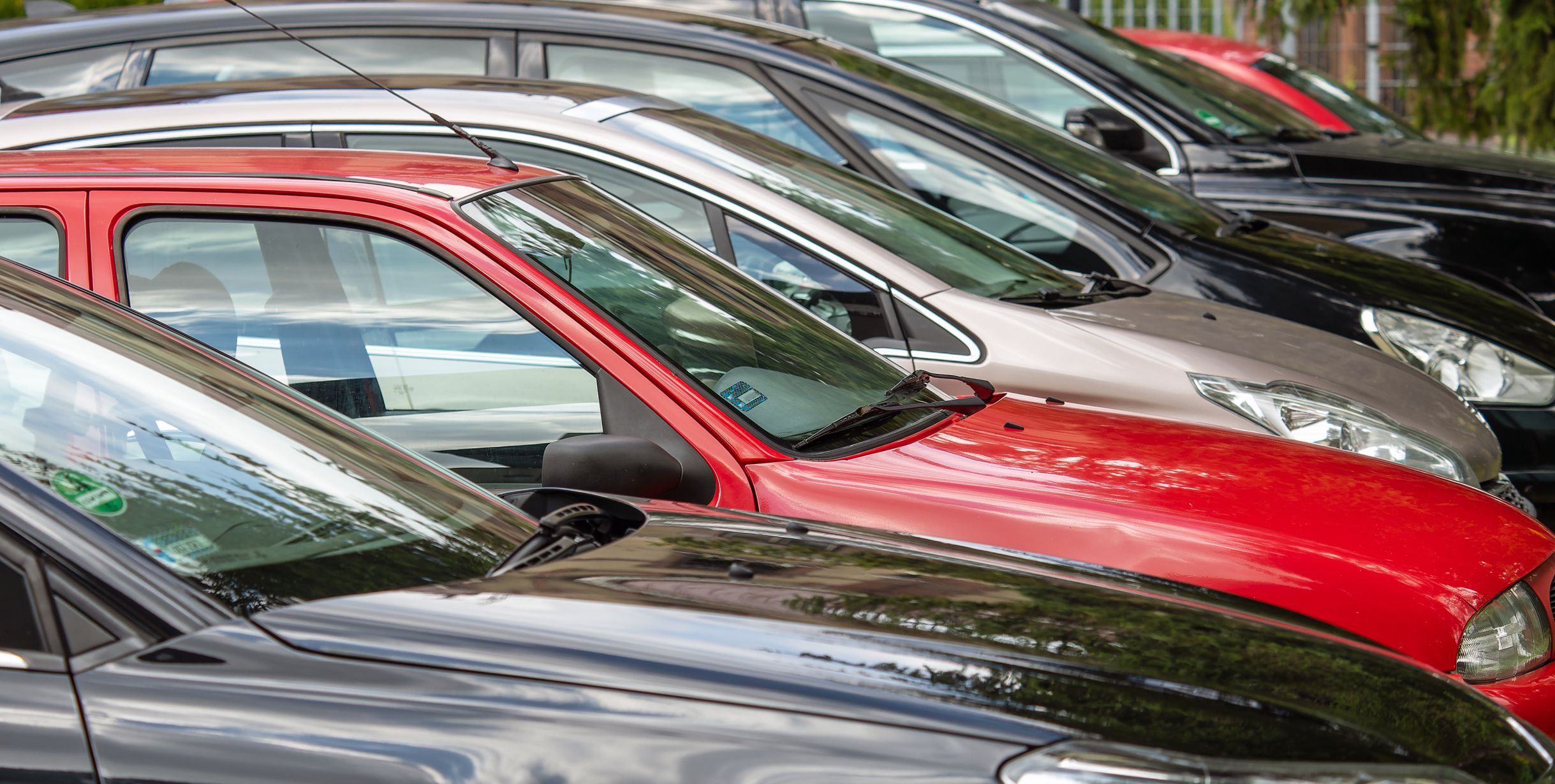 Different colored cars parked next to each other