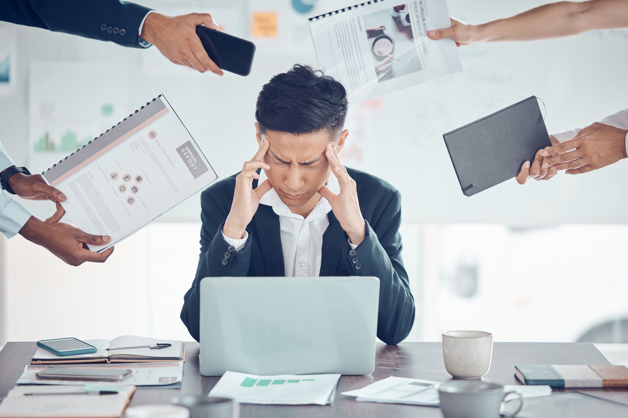 Stress, tired and business man with burnout, headache and frustrated work pressure with hands of employees giving task. Manager, mental health and data analyst male stressed and depressed at desk