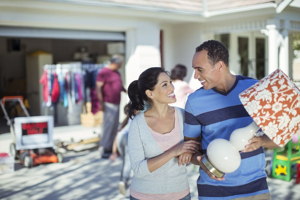 Happy couple buying lamp at yard sale