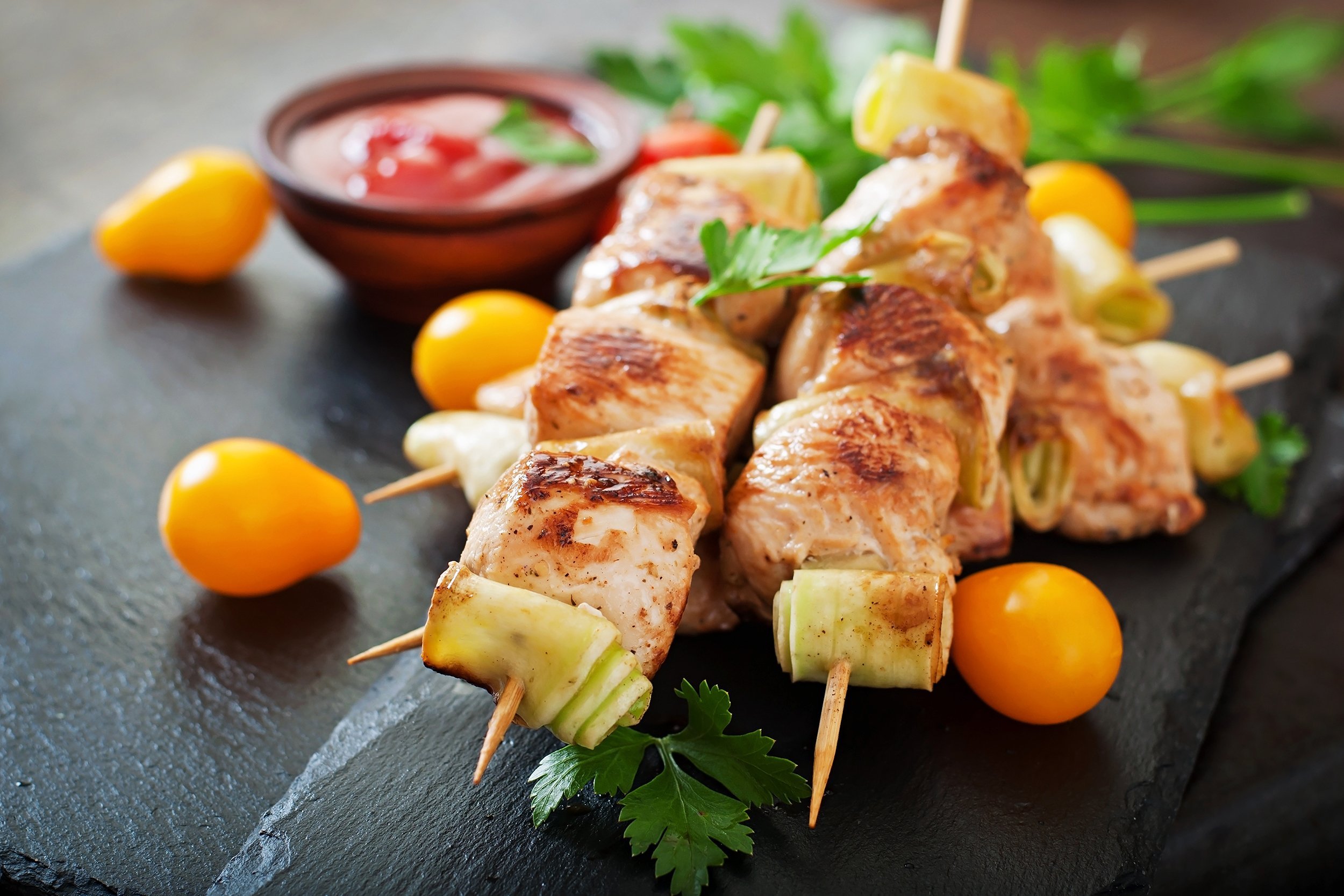 Chicken Shish Kebabs on Wooden Skewers with Orange Cherry Tomatoes