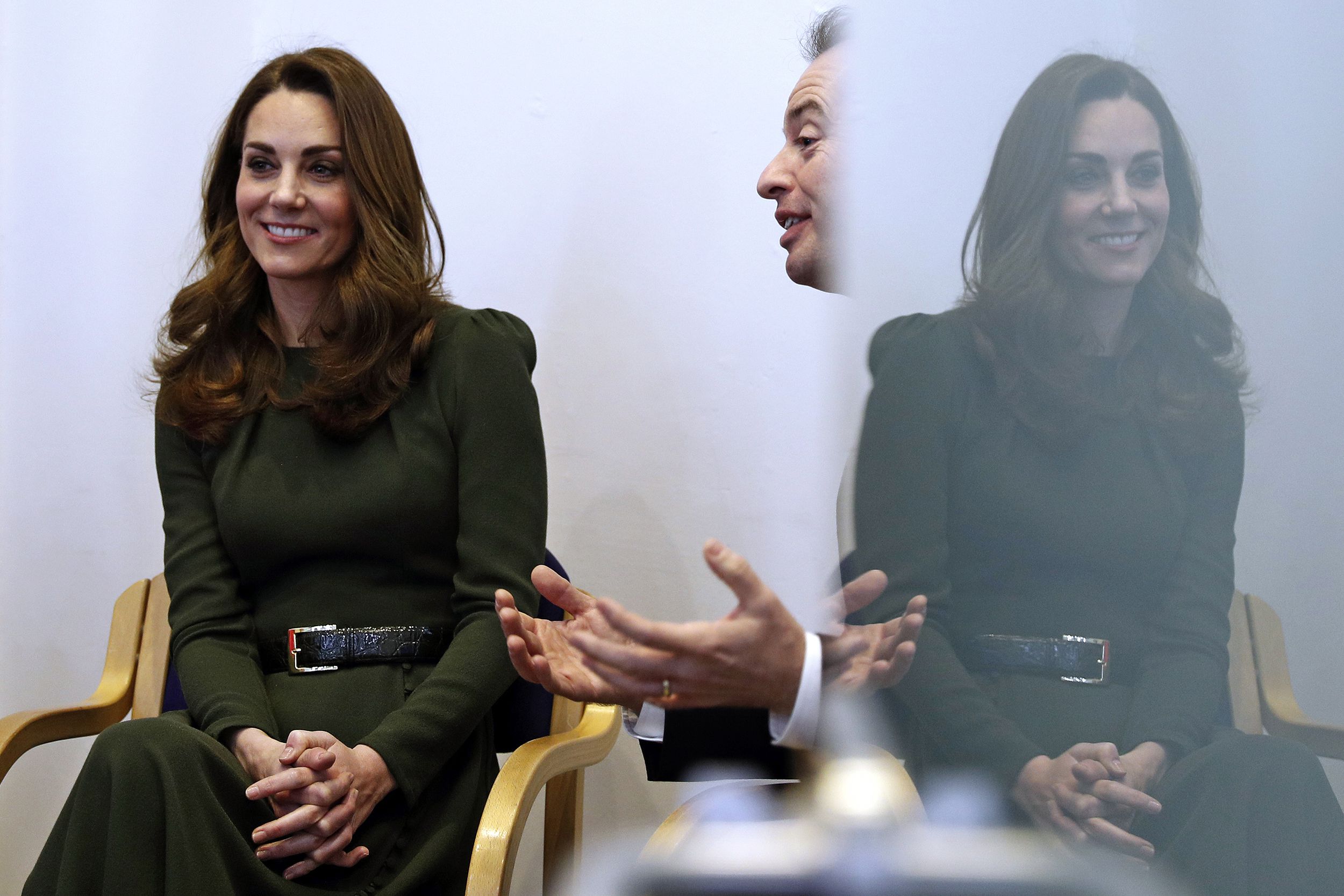 Catherine, Duchess of Cambridge (L) sits with Family Action CEO David Holmes (R) as he speaks with people supported by the charity, during a visit to a new national support line at the charity, Family Action on January 22, 2019 in Lewisham, England.