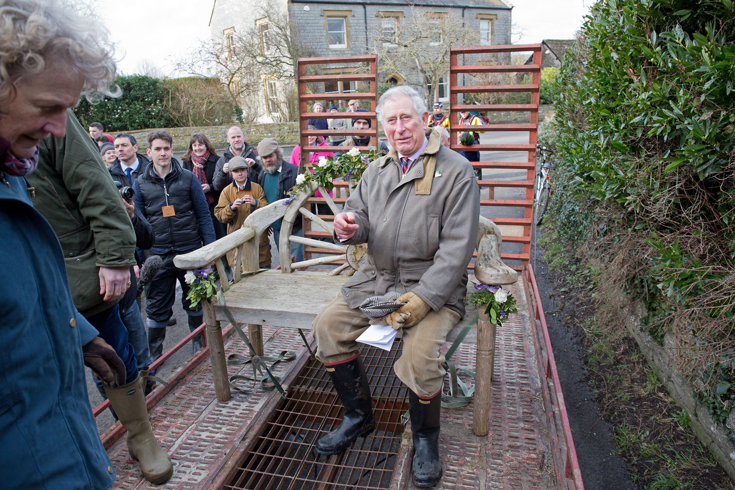 Prince Charles, Prince of Wales sits on a trailor which transports residents of the the flood hit village of Muchelney on February 4, 2014 in Somerset, England.
