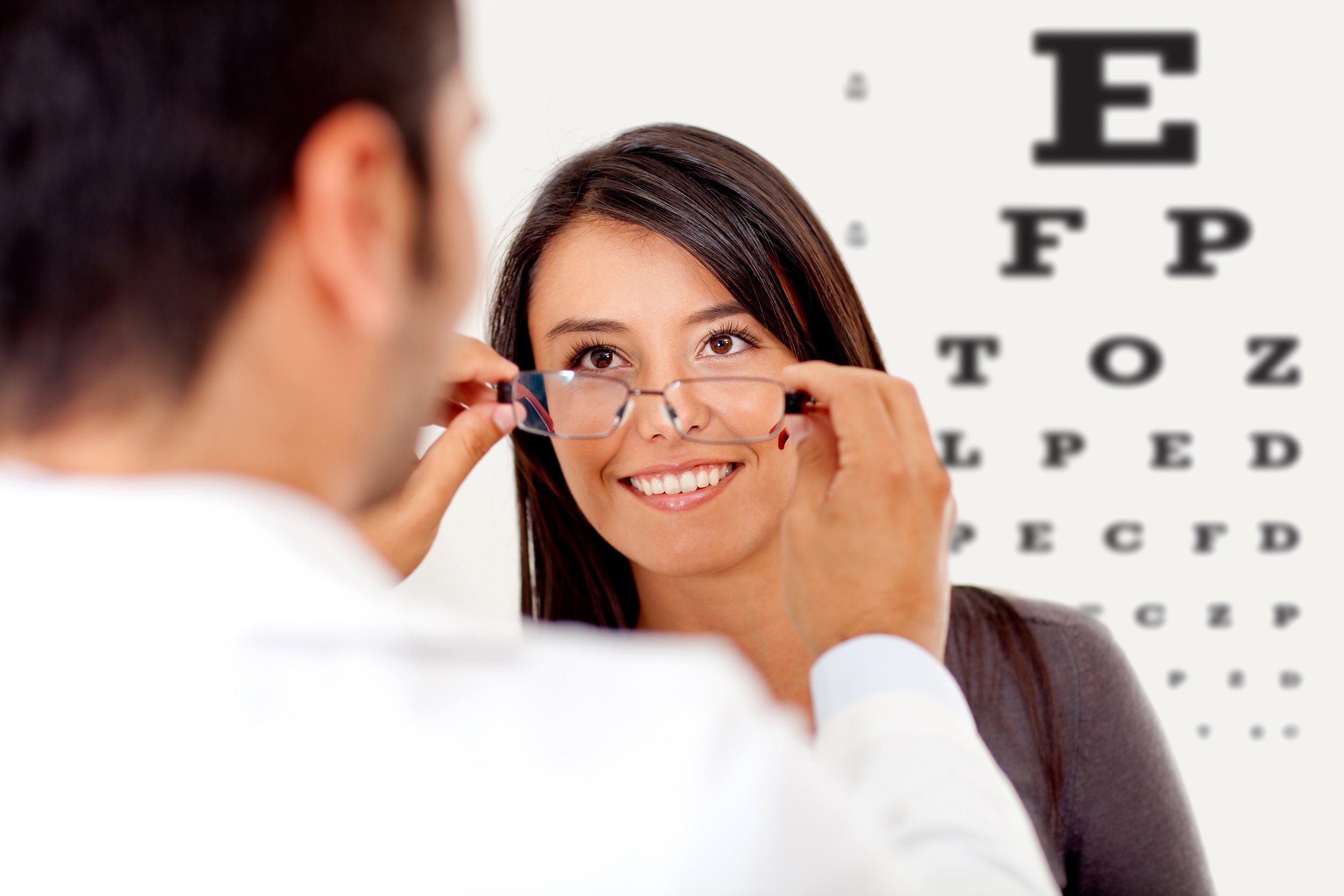 ethnic woman wearing glasses after taking a vision test at the doctor
