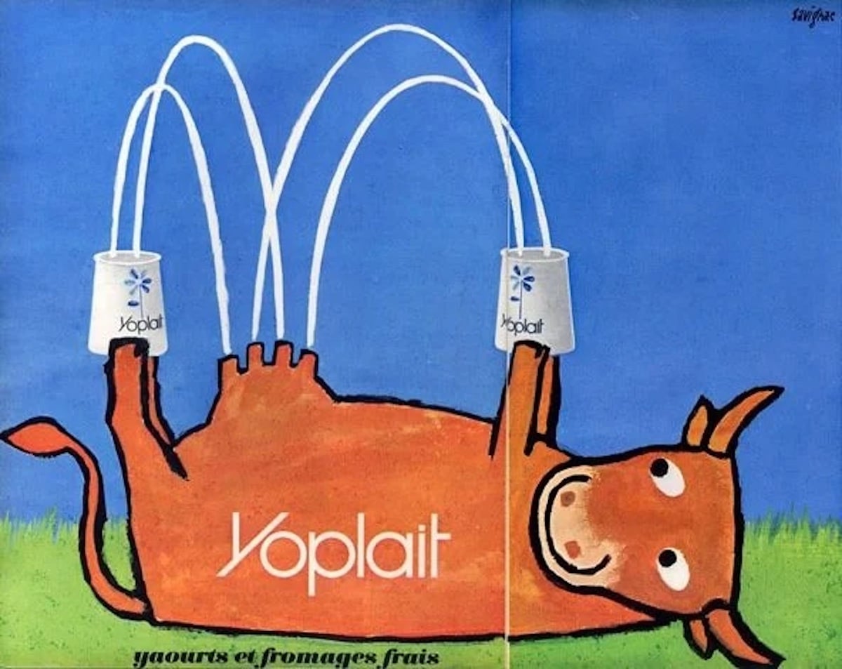 A playful cartoon cow lies on its back in green grass, holding two Yoplait yogurt cups as if milking itself, streams of milk arching into the cups. The blue background and "Yoplait," one of the companies founded by year 1965, appear on the cow’s body.