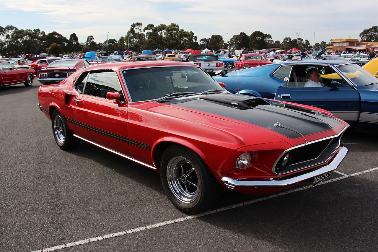 1969 Ford Mustang Mach 1 Sportsroof Candyapple Red. The 1969 Mustang got a new body, nearly 4 inches longer than the 1968 model. The Fastback was now called the Sportsroof and the sporty model was now the Mach 1, it got sports suspension, reflective stri
