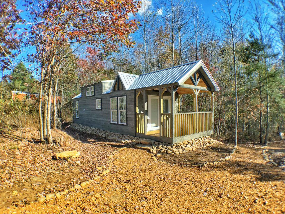 A tiny home made by River Ridge Escape, Georgia, on a plot of land in a tiny home community on a sunny day