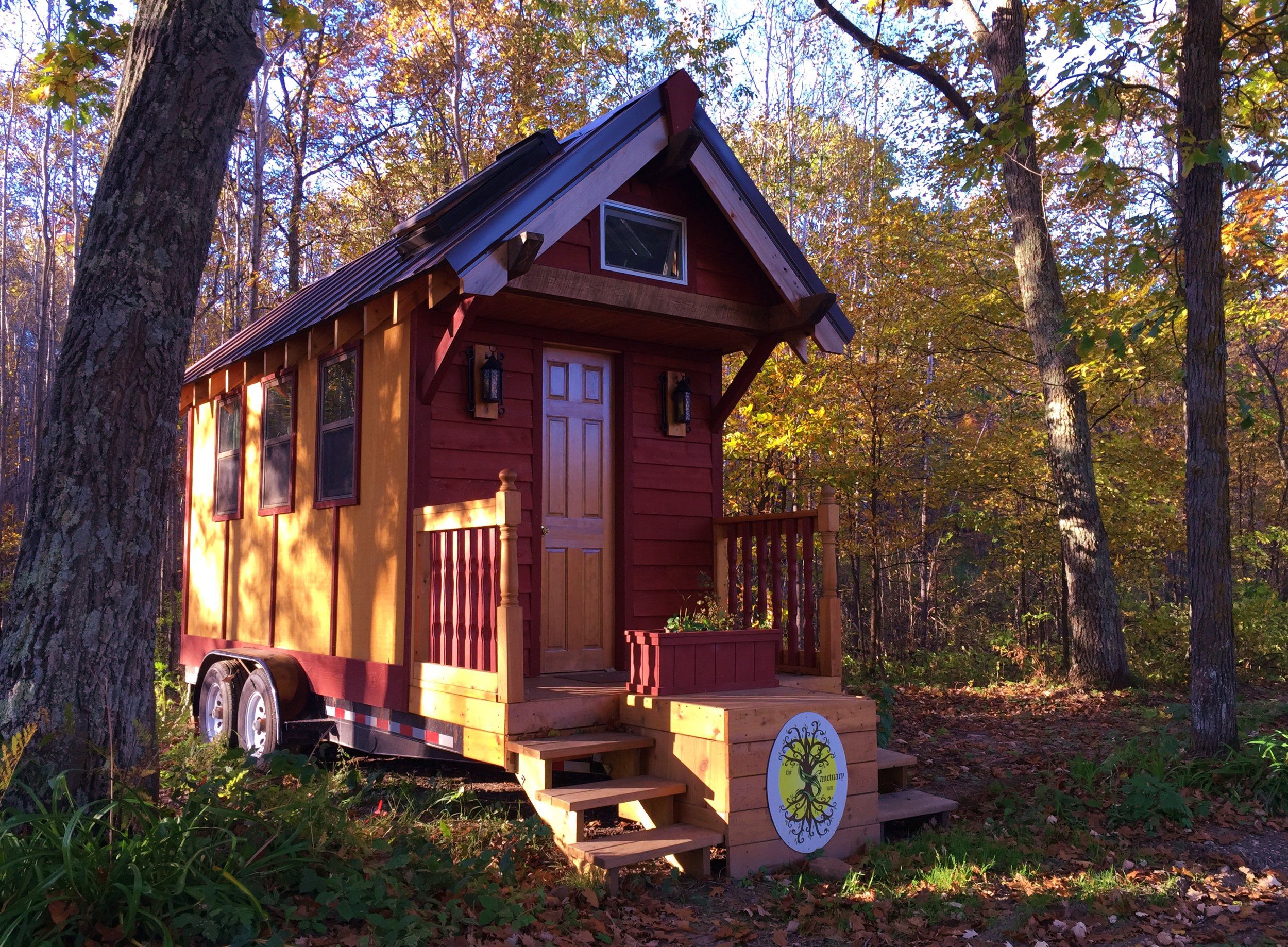 A tiny home in The Sanctuary Minnesota, Ogilvie, Minnesota, surrounded by trees and forest