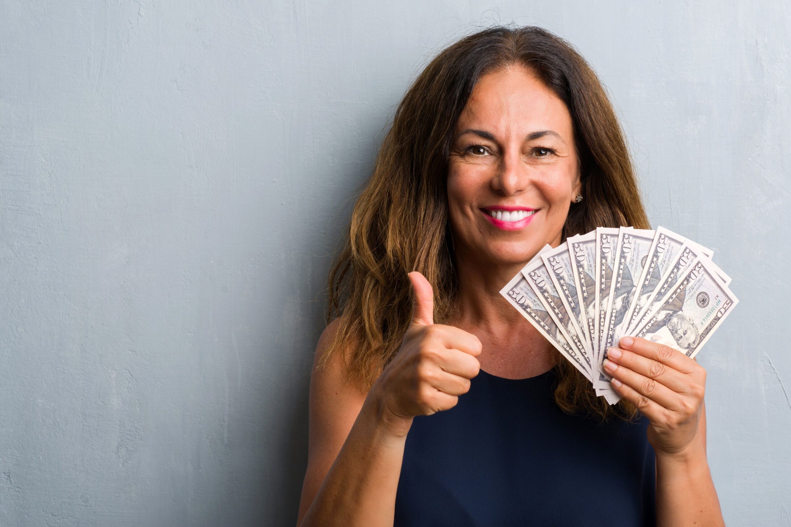 Happy woman holding money