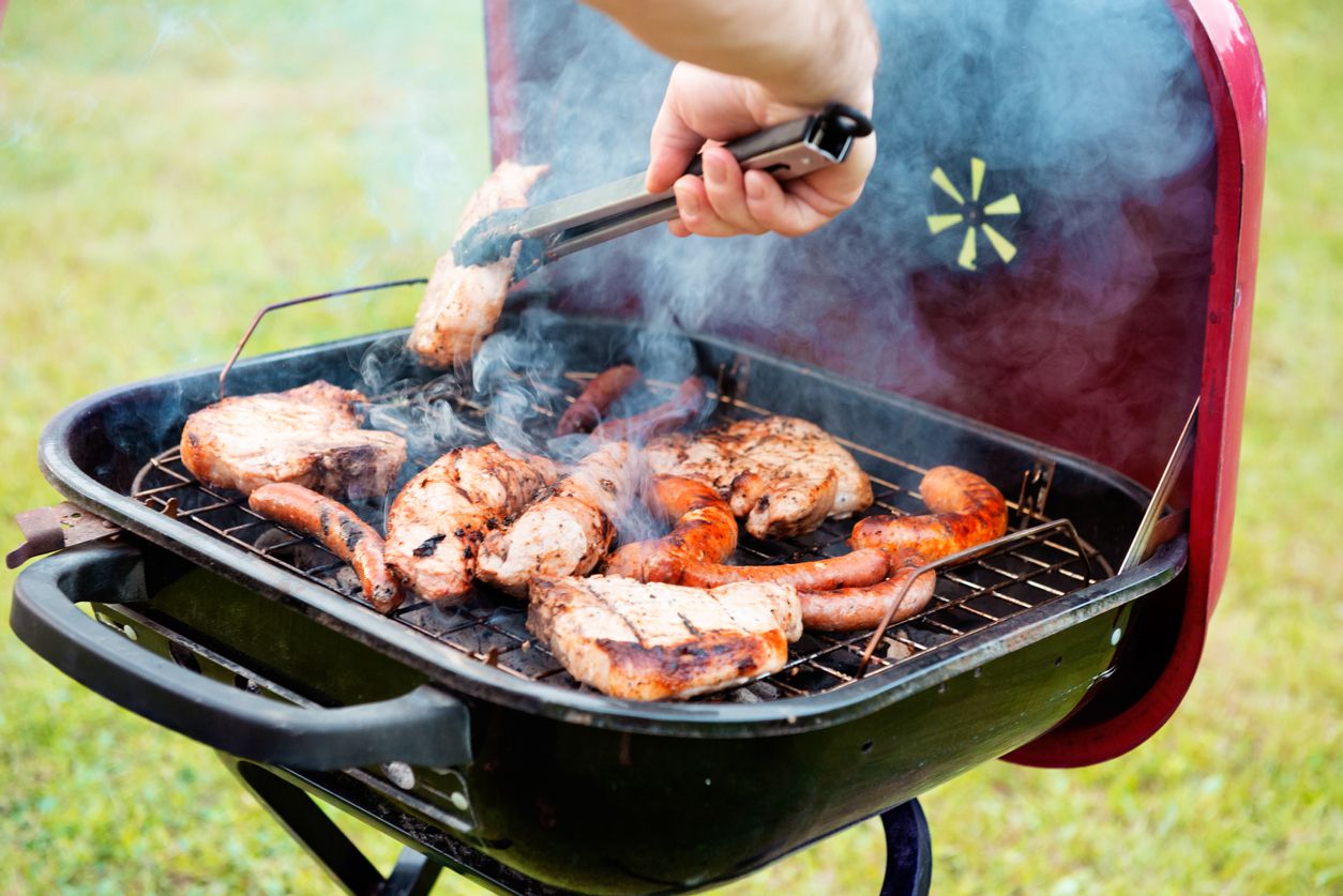 summer barbecue of chicken, chops and sausage