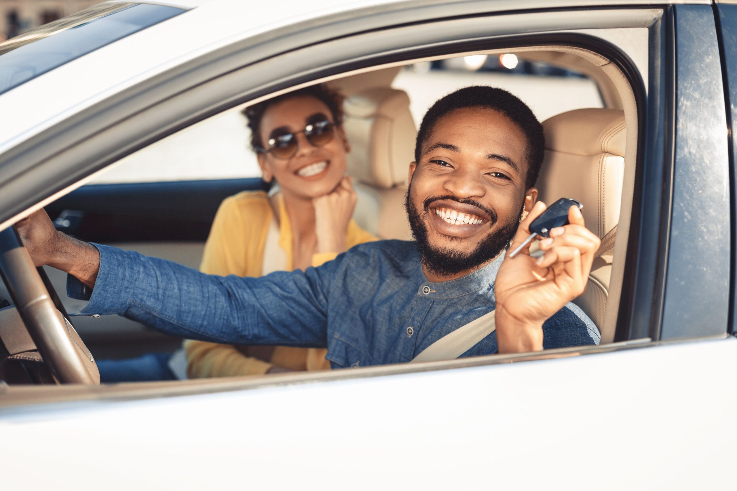 Happy couple in a new car