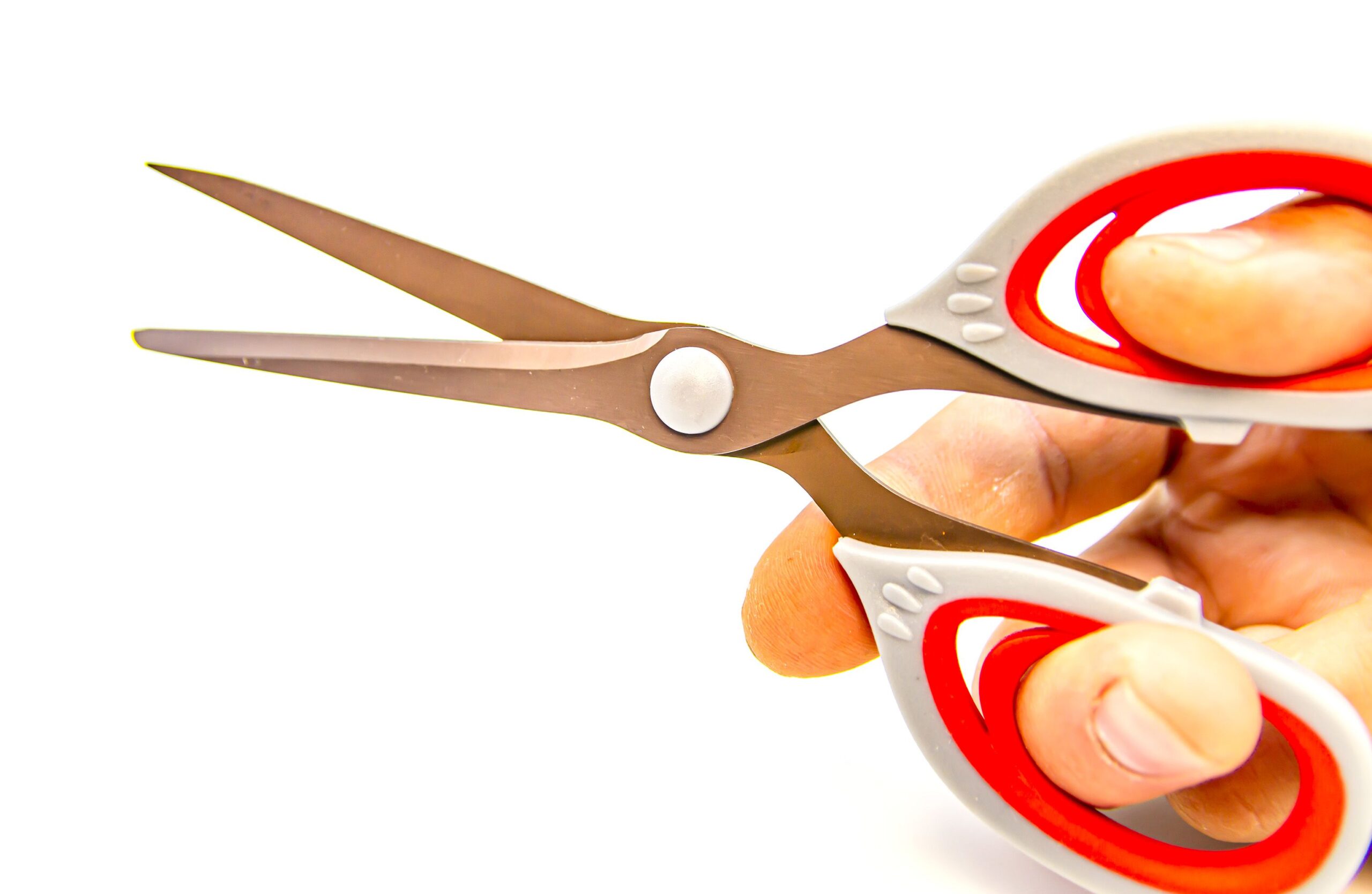 Scissors in a hand on a white background. Tool. Background.