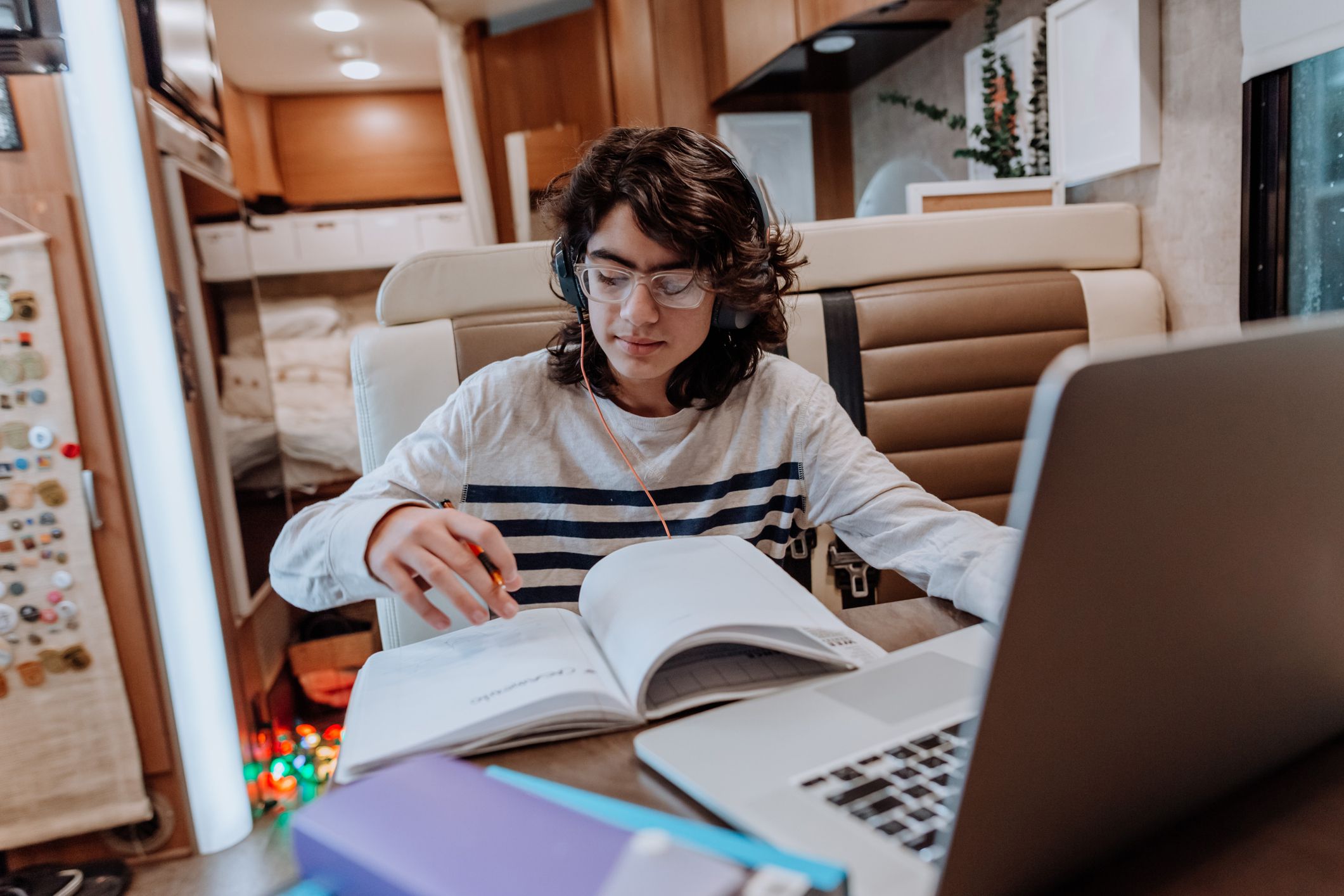 teenager doing homework on motor home