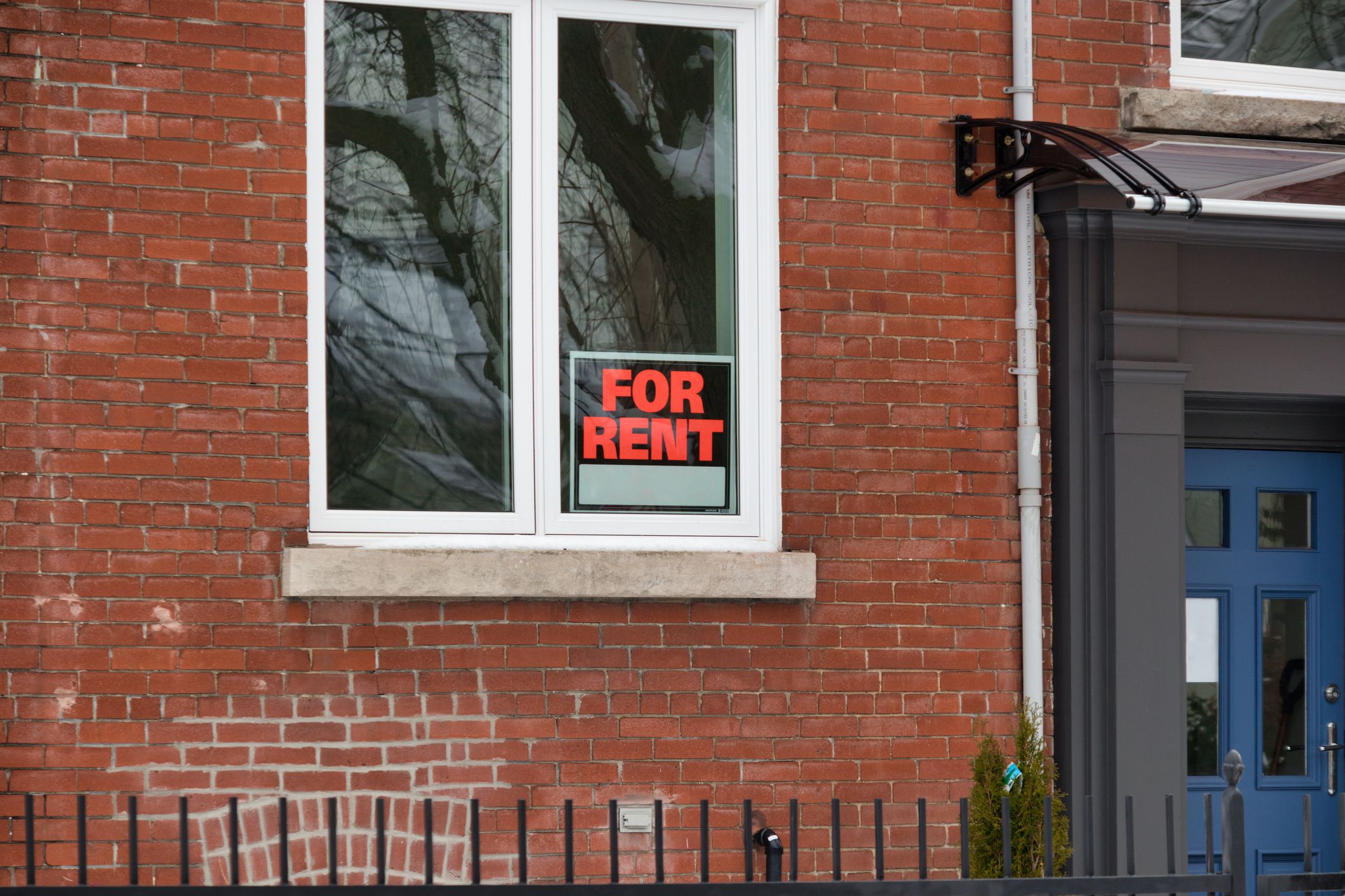 A for rent sign in the window of a House
