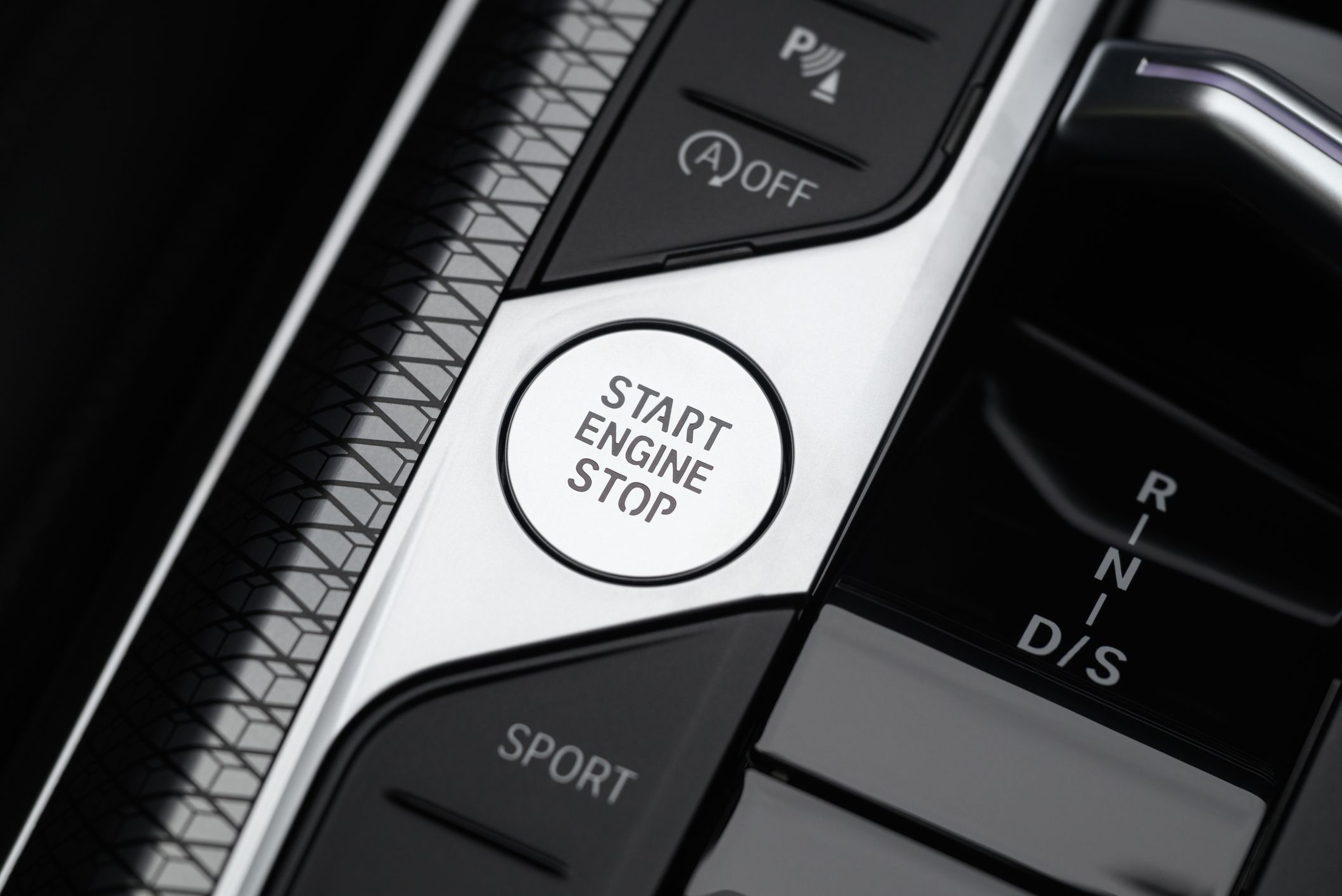 Keyless engine start/stop button in a car.