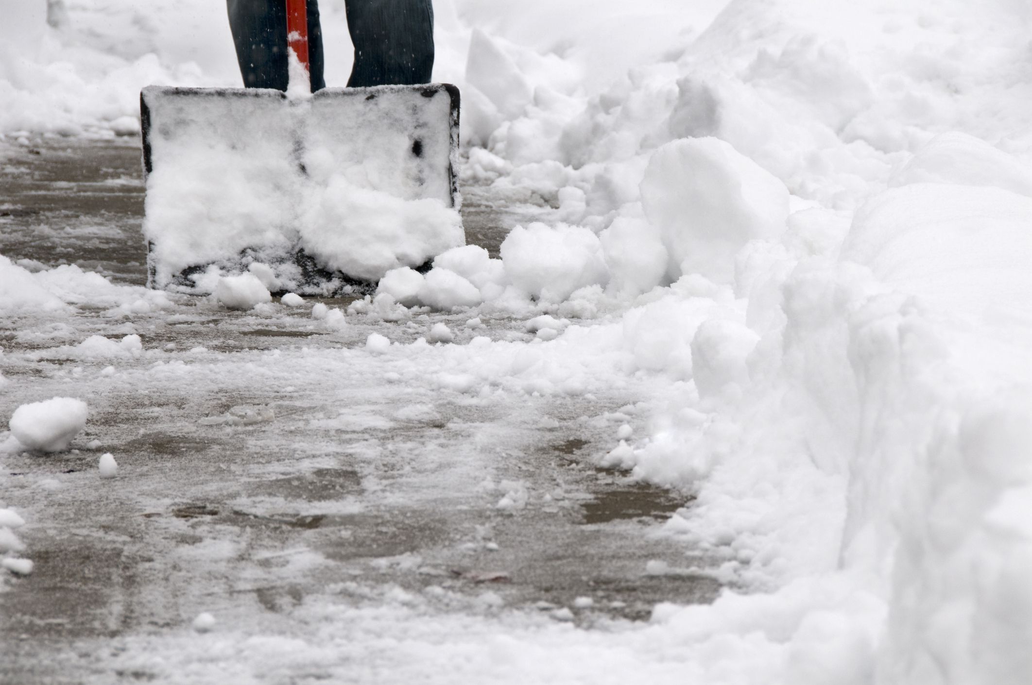 clearing heavy wet snow from the sidewalk after a winter storm.See more related images in my Winter Snow Removal lightbox: