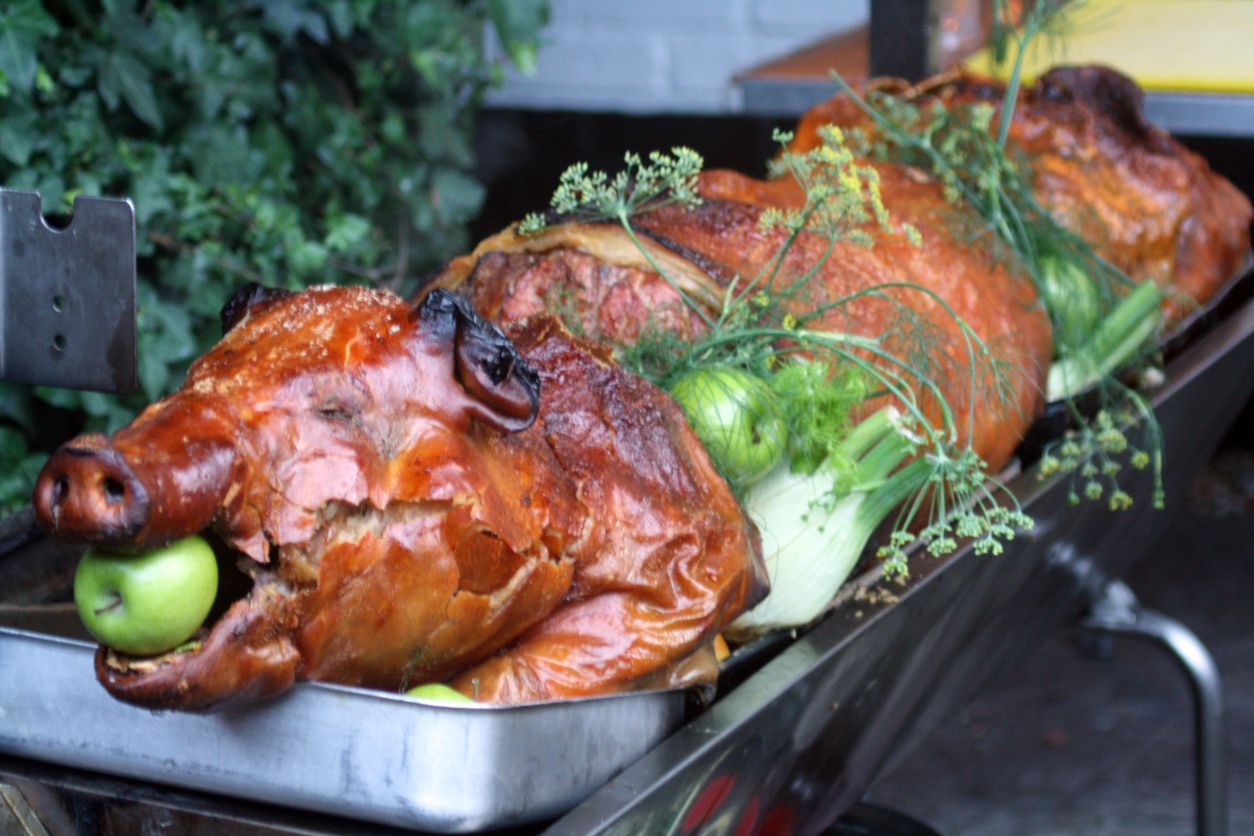 roast pig with apple stuffed in its mouth