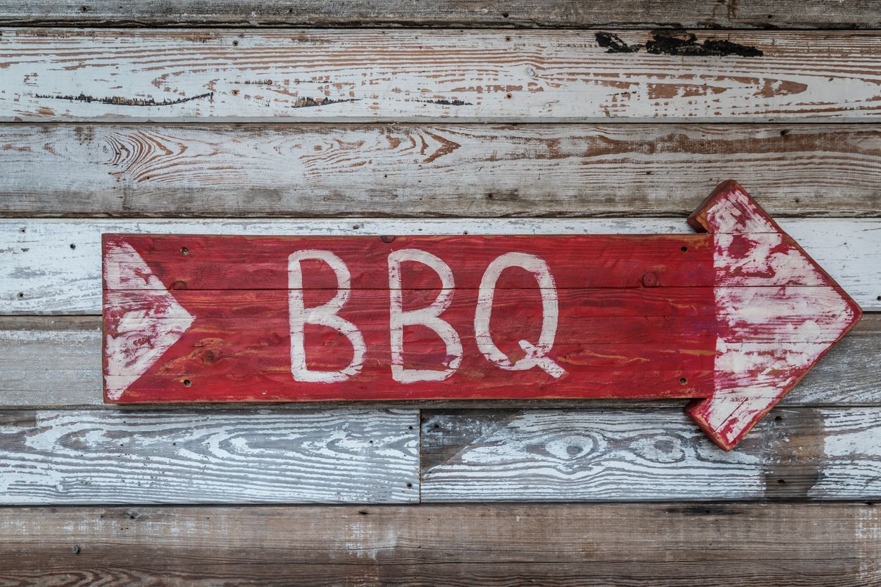 weathered wooden sign that say bbq