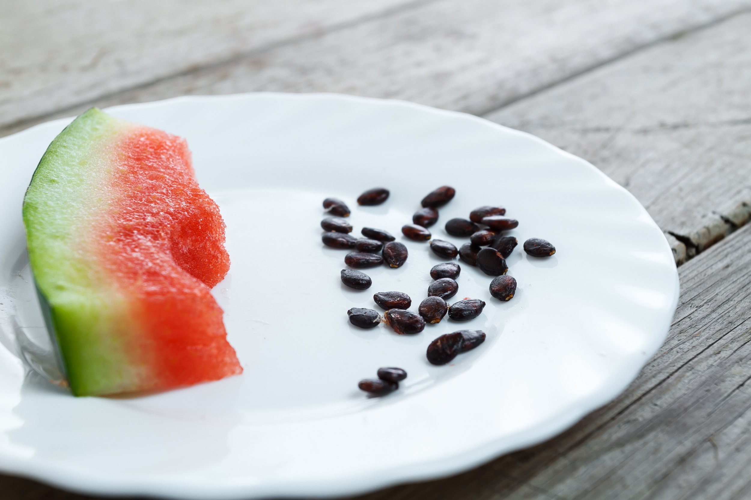 eaten slice of watermelon with watermelon seeds