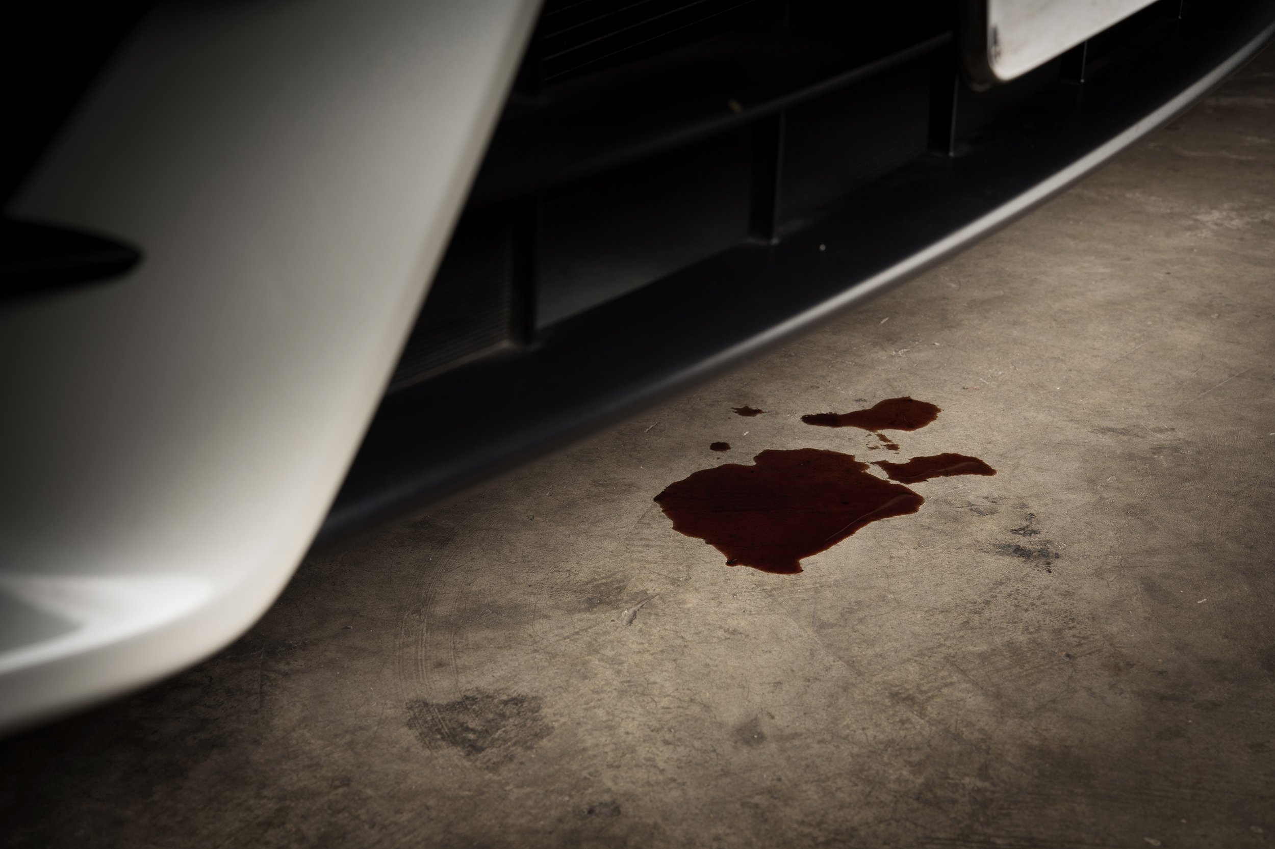 old black oil used of car auto mobile leak and drop on concrete floor