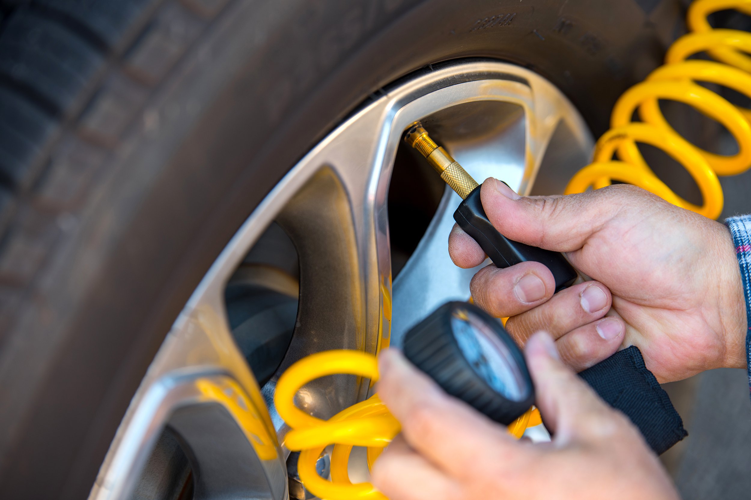 adding air to car tire
