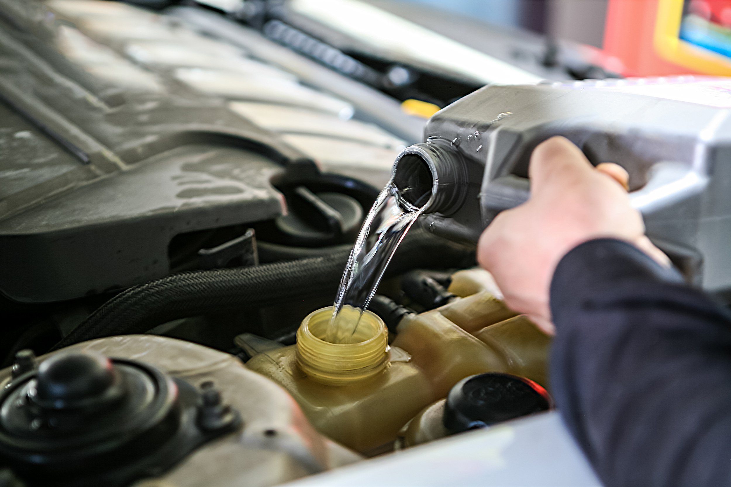 pouring car coolant in car
