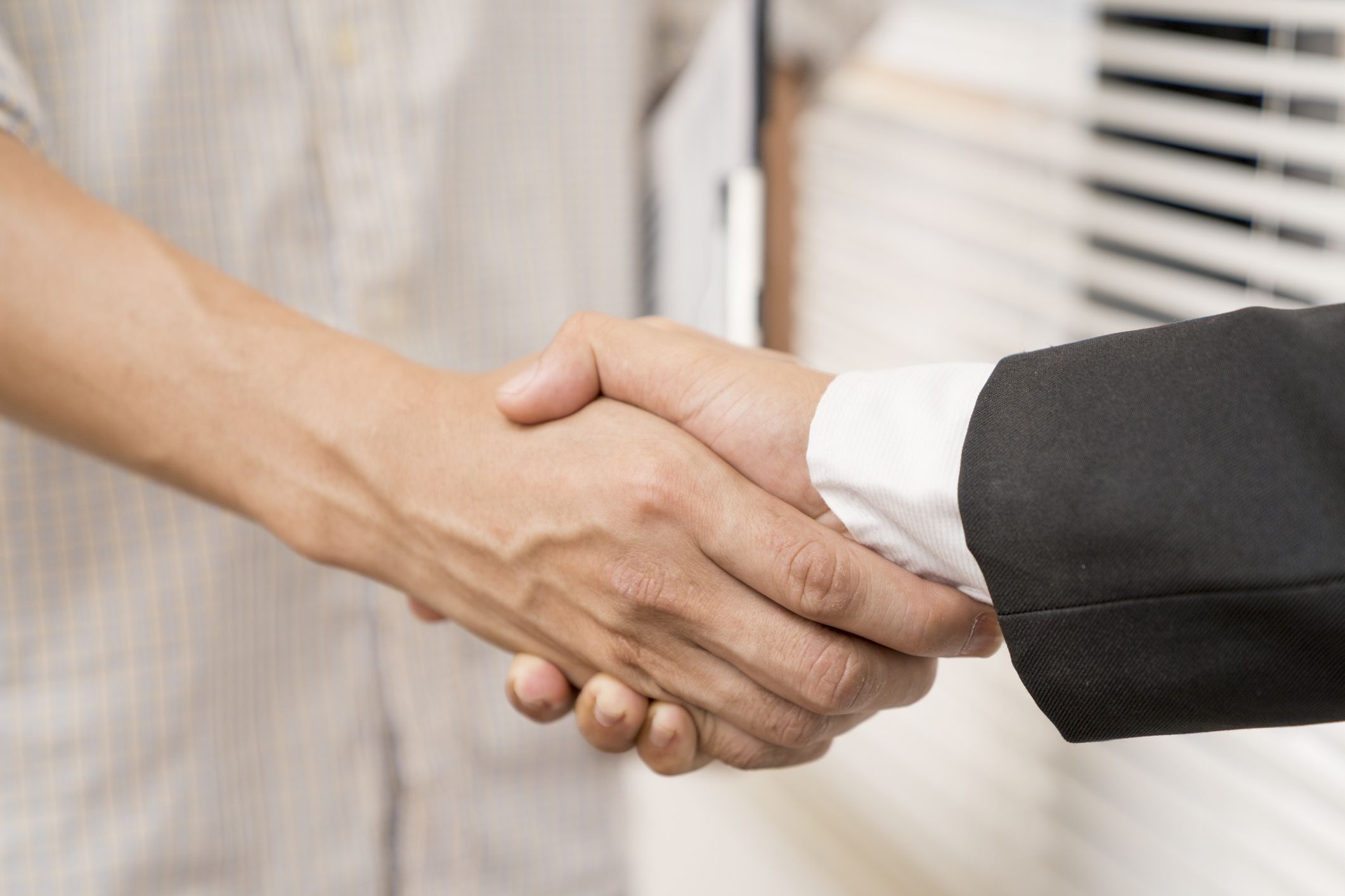 Banker business man shaking hands with client and sign contrac document for comfirm corporation or finished loan agreement for house or building property.Docum
